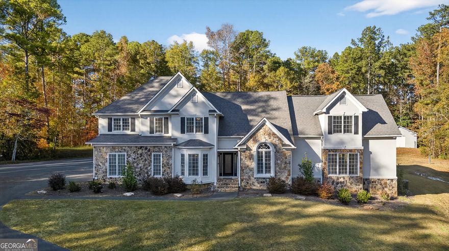 Welcome to this impressive Newnan estate, offering multiple living spaces, a sparkling heated pool, and a private pickleball court, all set on a secluded, picturesque lot. Step through the front door to find a formal dining room with a bay window and an office with double doors. The heart of the home is the inviting living room, featuring soaring ceilings and a beautiful fireplace. The open-concept kitchen includes stainless steel appliances, a tile backsplash, a pantry, and plenty of cabinetry, with an eat-in dining area that overlooks the backyard oasis. Just off the main living room is a large secondary living space complete with built-in cabinetry and an entertainment center, an ideal spot for gatherings or movie nights. This home features two primary suites, each offering privacy and comfort. One suite is completely separate with its own staircase and an en suite bath featuring a large stand-up shower. The second primary suite, accessed by a separate staircase, includes a spacious sitting area, a luxurious en suite bath with a soaking tub and tiled shower, and a walk-in closet. Two additional guest bedrooms and a full bath complete the upstairs. Step outside to your private retreat featuring a pool with dual waterfalls, lounge seating, and a Cool Deck surface. Enjoy your own pickleball court, firepit area, and plenty of room for recreation or relaxation. A shed provides convenient storage for outdoor essentials, and parking is plentiful with both an attached two-car garage and a detached two-car garage, plus an extended driveway and RV parking with 50-amp electrical service. This remarkable property has it all just minutes from everything Newnan has to offer. Southeast Mortgage is our preferred lender. If buyer chooses to work with them, Southeast Mortgage will provide 1% credit up to $5,000. Reach out to the listing agent for more information.