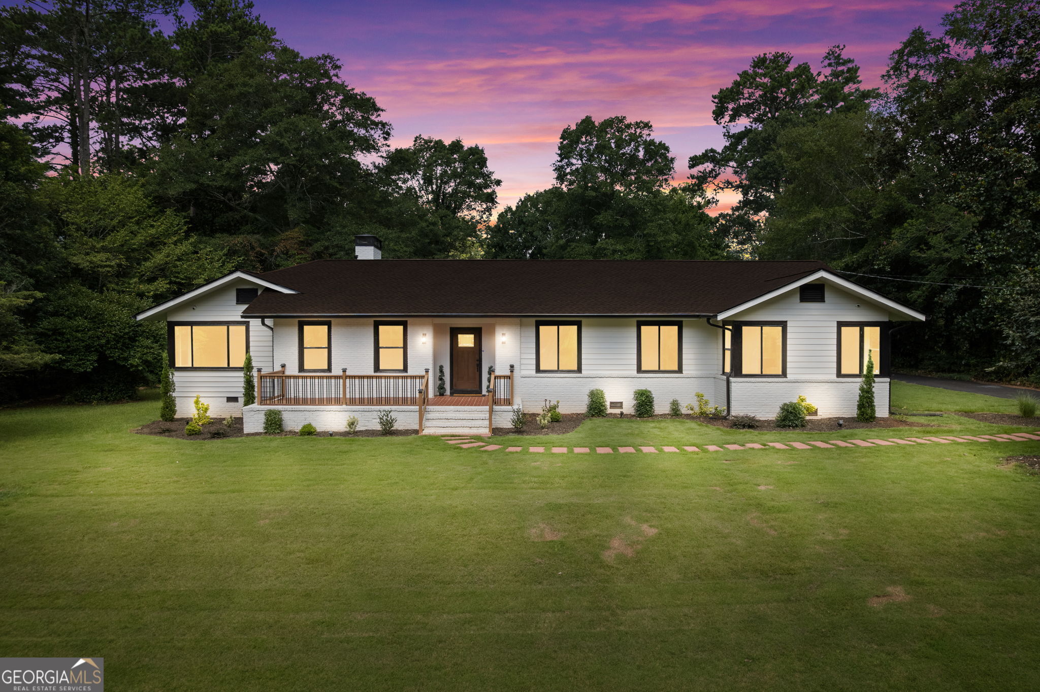 Wow, wow, wow!!! This fabulously renovated move-in ready 4 bedroom, 3 bath stately ranch in Forrest Hills sits upon 1.04 acres in an exceptionally peaceful setting nestled among beautiful fragrant Magnolia trees, an astounding 35-year-old Camellia tree, green and lush landscaping and a partially fenced back yard, ideal for leisure and fun in the great outdoors. This captivating home has only had 2 owners and the previous owner owned it for 70 years. Although the current owner has pretty much renovated every inch of this 3468 square foot home, he still left some of its very valuable charm. Some of the recent upgrades include a new Timberline architectural roof on the home, the new 2-car detached garage and the existing outbuilding for aesthetic continuity. The new fully finished 2-car detached garage is well lit and comes complete with a garage door opener and electrical outlets. There are new double paned energy efficient windows throughout, new exterior and interior neutral palette color paint, new entry doors and hardware, new railing and refurbished front porch tile, new sod and landscaping, expanded parking pad, new asphalt driveway coating, gleaming original hardwood floors that have been newly sanded, stained and sealed with 4 coats of protective polyurethane, new interior doors and door hardware, completely reconfigured kitchen with new custom soft close kitchen cabinets, some of which have 2-tier Lazy Susans, deep drawers and pullouts, new cabinet hardware, new granite countertops, new modern porcelain backsplash, new kitchen island, new sink, new faucet, new modern Samsung stainless steel appliances to include a smart microwave that can be operated via an app, renovated dual kitchen pantries, new flooring, new laundry room complete with a new Samsung washer and dryer, new light fixtures, ceiling fans and recessed lighting throughout, new fireplace mantle and a completely refurbished chimney. There are 3 designer inspired bathrooms, 1 of which is an addition and has a new walk-in tiled shower, new shower fixtures, new LED no-fog vanity mirror, new vanity, new toilet and new flooring. Another secondary bathroom has a new separate walk-in tiled shower, new dual vanities, new granite countertop, new sinks, new faucets, new rain shower head, new separate tub, new toilet, new lighting and new tile flooring. Thoughtfully designed, the split bedroom floor plan ensures privacy in the primary en suite with an abundance of new windows that bring in a wealth of natural sunlight. The primary bathroom is a stunner with an amazing custom tile wall surrounding a new stand alone soaker tub, new custom tiled shower, new shower fixtures, new double vanity, new faucets, new vanity mirrors, new lighting, new toilet, and a huge walk-in closet you've always yearned for. There are new 5-inch baseboards throughout and new GFCI outlets and outdoors, there are new foundation vent wells and a newly painted 8 x 10 storage building. The 4th bedroom could also be styled as a home office. The owner thoughtfully had the air ducts professionally cleaned and replaced the vent registers throughout. The HVAC has been serviced, new thermostats installed, most of the plumbing has been replaced and the kitchen and bathroom floors had been reinforced prior to installing new flooring. A new security system has been installed with cameras inside and outside with an in-home camera monitoring station along with a new Ring doorbell, all of which will stay with the home. Its location is within 2 miles of Downtown Griffin and is in the heart of town where tree-lined streets abound. Although very close to a variety of shopping, recreation and dining options, its location is comfortably tucked away from the maddening hustle and bustle. The current owner has spared no expense in bringing new life to this exquisite property. Now it's your turn to make it "home."
