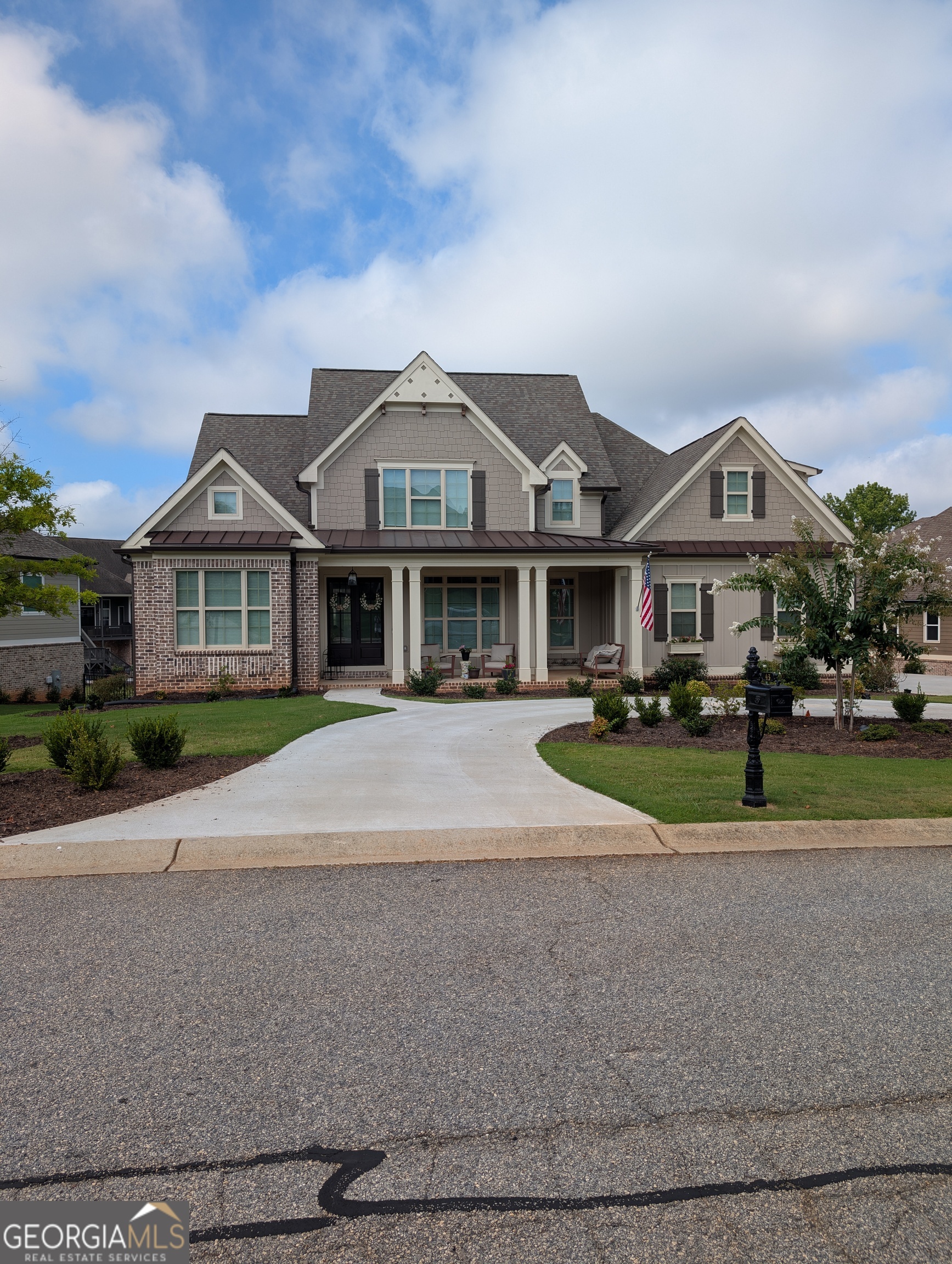 Welcome home - a charming 5 bedroom, 3.5 bath, Craftsman home built in 2022 in the highly sought after Traditions of Braselton Golf and Country Club located in an exclusive cul-de-sac with beautiful complimentary homes. This amazing home features many thoughtfully, appointed upgrades throughout. This home offers designer touches including beautiful, thick, heavy 12 MIL LVP/ Pergo flooring throughout, recessed LED lighting, tile bathroom floors, wainscoting, crown molding, shiplap accent, beautiful, solid two-panel Craftsman-style doors throughout, flat light switches, hot water recovery with quick hot water throughout the home, upgraded, black plumbing fixtures, door handles, and lighting. Levolor cellular shades throughout. Oversize 18 x 8 garage carriage style door. This home also features a front, circular driveway. A covered front porch with stained wood tongue-in-groove plank ceiling welcomes you to this beautiful home. This home offers an open-concept family room and kitchen, which makes entertaining a breeze. The soaring, vaulted ceiling in the family room, and 9 foot ceilings on the first floor, allow natural light to flood in. The family room features an oversized (60 inch) electric fireplace with heat and multiple display options with remote. The fireplace mantle is made of distressed oak beam with vaulted shiplap. Large, double 8 ft. French doors with transoms lead to a vaulted covered porch with stained, tongue in groove ceiling that overlooks a beautiful, large backyard. The kitchen is a chef's delight with white shaker upgraded cabinetry with soft close drawers and black handle pull bars, upgraded large upper cabinets include glass, upgraded granite countertops, a large, granite island is accented with pendant lighting, tile backsplash, stainless steel farm sink with no-touch faucet and counter push button garbage disposal. Stainless steel appliances include 36 inch induction cooktop with pot filler above, microwave/convection oven combination, a single convection oven, dishwasher with 3rd rack, and fabulous, large commercial style refrigerator and freezer. Many storage options including walk-in pantry with built-in wood shelving. The dining room is located right off the foyer with stunning craftsman trim and coffered ceiling. Spacious laundry located off the garage includes an industrial, stainless steel double sink and built-in ironing board. A vaulted Primary Bedroom on the main floor has his and her walk-in closet. Off the Primary Bedroom is the vaulted ensuite bathroom which features his and her vanities with granite counter tops, a relaxing, stand alone, large soaker tub, an oversized shower with seamless glass enclosure including primary shower head and additional rain shower unit, and a linen closet for storage. Also located on the main floor is a guest bedroom and separate bathroom for accommodating guests. The black metal balusters on the staircase lead to the upper level where you will find two bedrooms which share a Jack and Jill bathroom as well as another oversized bedroom with a 3 piece bathroom (shower, lav, and sink). There is also a study/office area on the second floor. Below the first floor is a large unfinished basement with plenty of light awaiting your transformation if desired. Two separate heating and cooling systems. Cement siding. Architectural roof with 6 inch gutters. Sprinkler system. Protected by Ring Security System. All curtain rods, curtains, and shades convey with the home. Neighborhood amenities include golf course, restaurant, clubhouse, pool, gym, 6 lighted tennis courts, and 4 pickle ball courts. Four additional tennis courts and eight pickle ball courts are under construction at this time and should be completed late summer. Located in Jackson County School District.