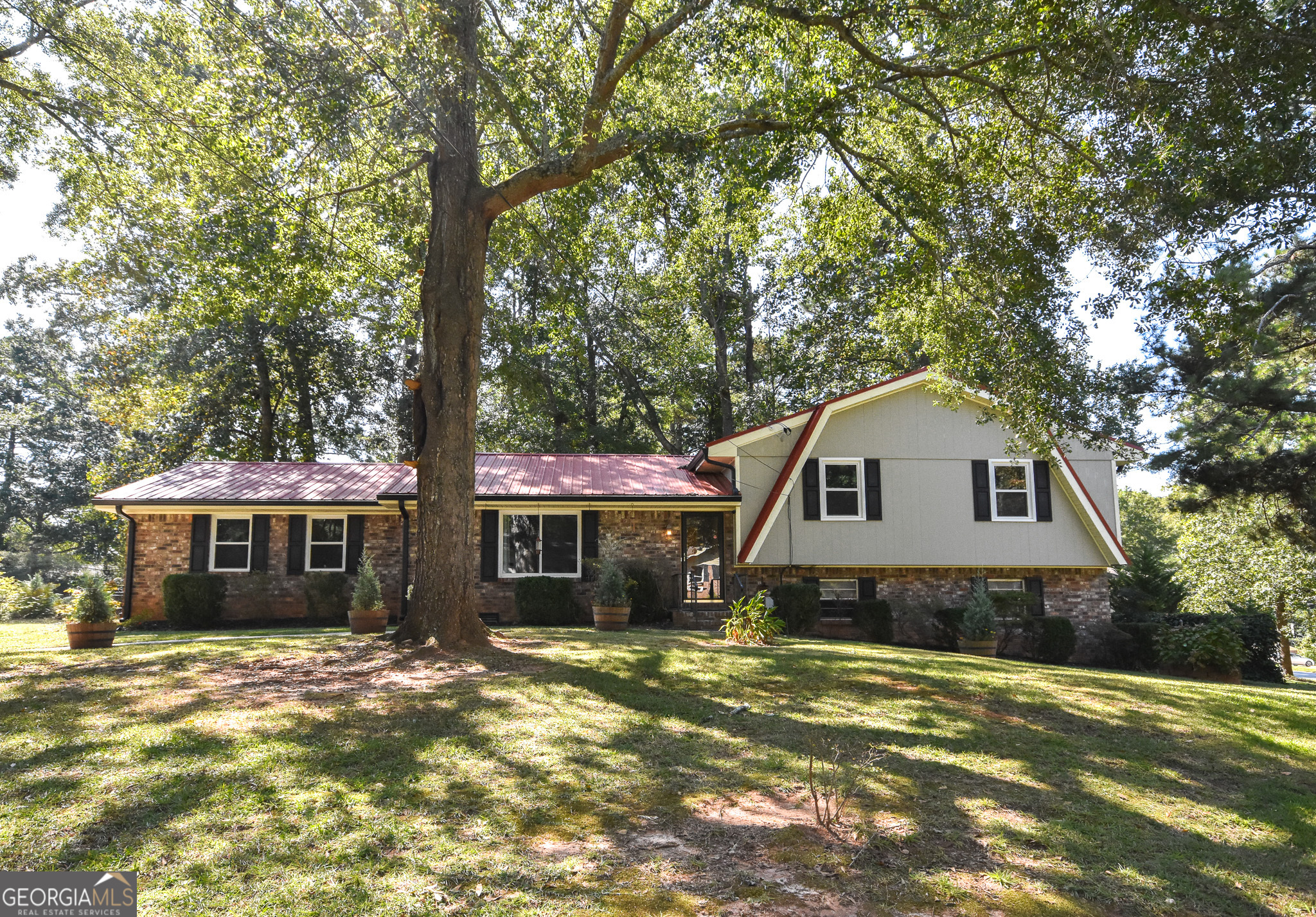 Charming multi-split 4 sided brick home in a prime location-just steps from schools, shopping, the amphitheater, public library, and tag office! This 3-bedroom, 2-bath home offers a spacious layout with a finished basement and metal roof. The upper level features 3 bedrooms and 2 full baths, while the lower level includes a bonus room, den, laundry, and a workroom. The kitchen boasts a breakfast area and comes equipped with new appliances: refrigerator, oven/range combo, microwave, and dishwasher. New LVP Flooring and carpet in select areas. Outdoor living is easy with a patio and a fenced backyard. Parking options include garage, parking pad, and off-street spaces. Community amenities include a nearby park with walk-to access for schools and shopping. Main maintenance items have all been upgraded in the last 3 years!