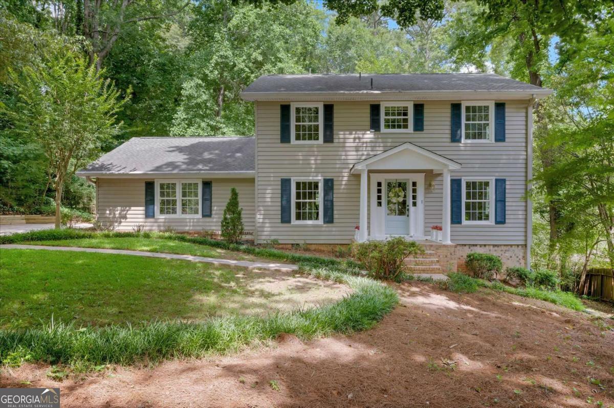 BEAUTIFULLY UPDATED TRADITIONAL HOME IN TOP-RATED WALTON HIGH SCHOOL DISTRICT! Nestled in a peaceful CUL-DE-SAC WITH A PARK-LIKE SETTING, this charming home blends timeless curb appeal with modern updates. A welcoming front portico sets the tone for this warm and inviting residence. Step inside to discover NEWLY REFINISHED HARDWOOD FLOORS and soothing SW Alabaster paint palette on the main level, a RENOVATED KITCHEN with richly finished stained cabinets, granite countertops, and a perfect sight-line to the family room! YOU WILL LOVE THE NEW, ELEGANT, MAIN LEVEL BATHROOM FEATURING A FURNITURE STYLE VANITY, BRUSHED GOLD HARDWARE, AND A SEAMLESS GLASS SHOWER. The main level is completed with a formal dining and living room. By the way, if you need a bedroom on the main floor, the living room can easily be converted to serve as one with a full bathroom on this floor. The UPSTAIRS FEATURES BRAND-NEW CARPETING, offering comfort and freshness, the owner's retreat with a luxurious, RENOVATED ENSUITE BATHROOM WITH A FARMHOUSE STYLE VANITY TOPPED WITH QUARTZ COUNTERS, three additional spacious bedrooms, and a newly renovated secondary bathroom with a sophisticated double vanity. For the additional space everyone needs you'll appreciate the FINISHED TERRACE LEVEL BOASTING NEW LVP FLOORING, surround sound speakers, and flexible space perfect for media, workouts, or entertaining. Enjoy serene outdoor living off the family room with a NEW DECK OVERLOOKING A GORGEOUS WOODED VIEW and a cozy firepit area-ideal for relaxing or hosting gatherings. More to make you happy, the ARCHITECTURAL ROOF IS 5 YEARS YOUNG! East Cobb is a sought-after area for so many reasons including top-tier schools, the Chattahoochee National Forest and Recreation areas, the Chattahoochee River, the Avenue of East Cobb outdoor, upscale shopping center with free outdoor concerts half of the year, restaurants, and a brewery to name some of the fun! Don't miss this move-in ready gem!