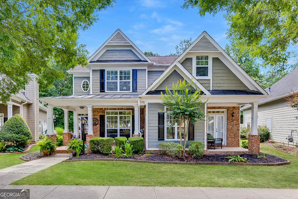 Priced to Sell! Move-In Ready with a Brand-New Roof! Welcome to this beautifully maintained 3-bedroom, 2.5-bath Craftsman-style home in the highly sought-after North Gwinnett School District. Tucked away in the heart of charming Old Suwanee, this home blends timeless curb appeal with modern updates including a brand-new architectural roof. Enjoy a classic rocking chair front porch, mature landscaping maintained by the HOA, and authentic Craftsman details throughout. Inside, bright and open living spaces feature soaring ceilings, elegant trim work, and an abundance of natural light. The dramatic two-story family room creates a warm, welcoming atmosphere for everyday living or entertaining. The updated kitchen boasts granite countertops, new stainless steel appliances, and ample cabinetry, flowing into a sunny breakfast area that opens to a second covered front porch ideal for morning coffee or casual gatherings. The main-level primary suite features tray ceilings, a spacious walk-in closet, and a spa-like en-suite bath with dual vanities, soaking tub, and separate shower. Upstairs, two additional bedrooms and a renovated full bath offer privacy and comfort for family or guests. Step outside to a covered patio and fully fenced backyard, perfect for relaxing, entertaining, or spending time with pets. All just minutes from Suwanee Town Center, parks, greenways, and top-rated shopping and dining this home truly checks all the boxes!