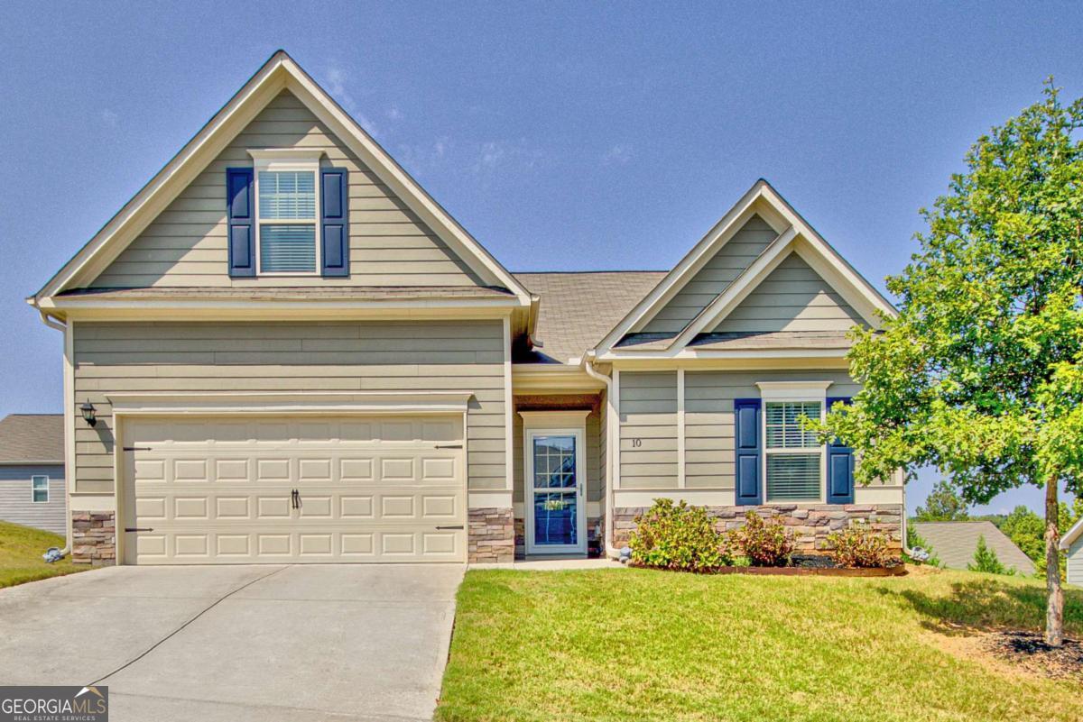 Welcome Home to this fabulous 4 bedroom, 3 full bath RANCH-style beauty! Purchased new as a model home in 2020, this property was thoughtfully designed with modern finishes, UPGRADES and smart touches that make it truly stand out! Step inside and fall in love with the OPEN CONCEPT great room and kitchen, perfect for entertaining or everyday living. The HUGE ISLAND, granite countertops, pendant lighting, crown molding, and wainscoting add style and function, while the durable laminate flooring throughout all common areas means easy upkeep. The kitchen is a chef's dream with all appliances included-only 5 years old-plus a brand new 3-rack dishwasher! Even the refrigerator, washer, and dryer stay, making this a true MOVE-IN-READY home! The Primary Suite is a private retreat, featuring a walk-in closet with a unique connection to the laundry room for added convenience. Enjoy the double sinks with cultured marble counters, tiled shower, and a separate soaking tub-the perfect place to relax and unwind. Upstairs, you'll find a spacious 4th bedroom/bonus room with its own full bath, large closet and walk-in attic storage-ideal for guests, a home office, or a media room. Out back, you'll love the OVERSIZED COVERED PATIO with a ceiling fan-a peaceful spot to enjoy morning coffee or evening breezes. With plenty of space, the patio could easily be enclosed for year-round enjoyment. Other highlights include: Fresh paint in the front bedrooms, hall bath, bonus room and bath. All NEW window and shower curtains included! High ceilings throughout for an airy, open feel. Storm doors on front and back doors. HOA community with public water/sewer. Termite service contract for peace of mind. All major systems are only 5 years old-nothing to worry about! This home truly offers the best of both worlds: the comfort of like-new construction with all the little extras already taken care of. Don't miss your chance to own this warm, inviting, and perfectly maintained home-schedule your showing today! 404-543-9495