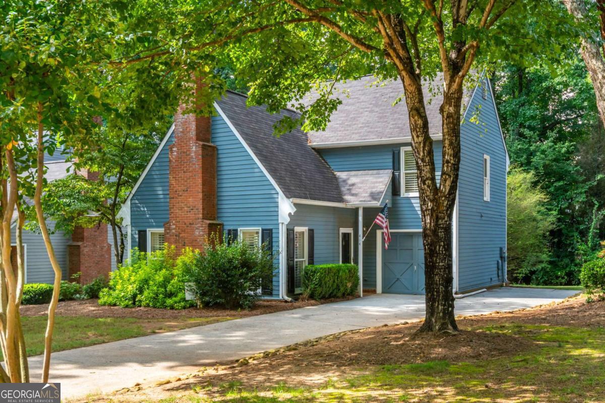 Welcome to 414 Roswell Green Lane, a turn-key 2-bedroom, 2.5-bath home in the sought-after charming community of Roswell Green. Just minutes from vibrant Canton Street in downtown Roswell, this home provides low maintenance living with close proximity to popular dining, shopping, parks, local schools, and more. The inviting main level living space features soaring vaulted ceilings and abundant natural light with a beautiful brick fireplace as the centerpiece. Durable, updated flooring runs throughout - no carpet! The renovated kitchen features white cabinetry, granite countertops, stainless steel appliances, and a breakfast nook making it both stylish and functional. Step outside to your private patio surrounded by lush landscaping, perfect for relaxation or entertaining guests. Upstairs, you'll find two spacious bedrooms and bathrooms including a generous primary suite with a double vanity, walk-in shower, and a large walk-in closet. HOA maintains all landscaping! With modern updates, timeless charm, and an unbeatable location, this home is a true gem in Roswell!