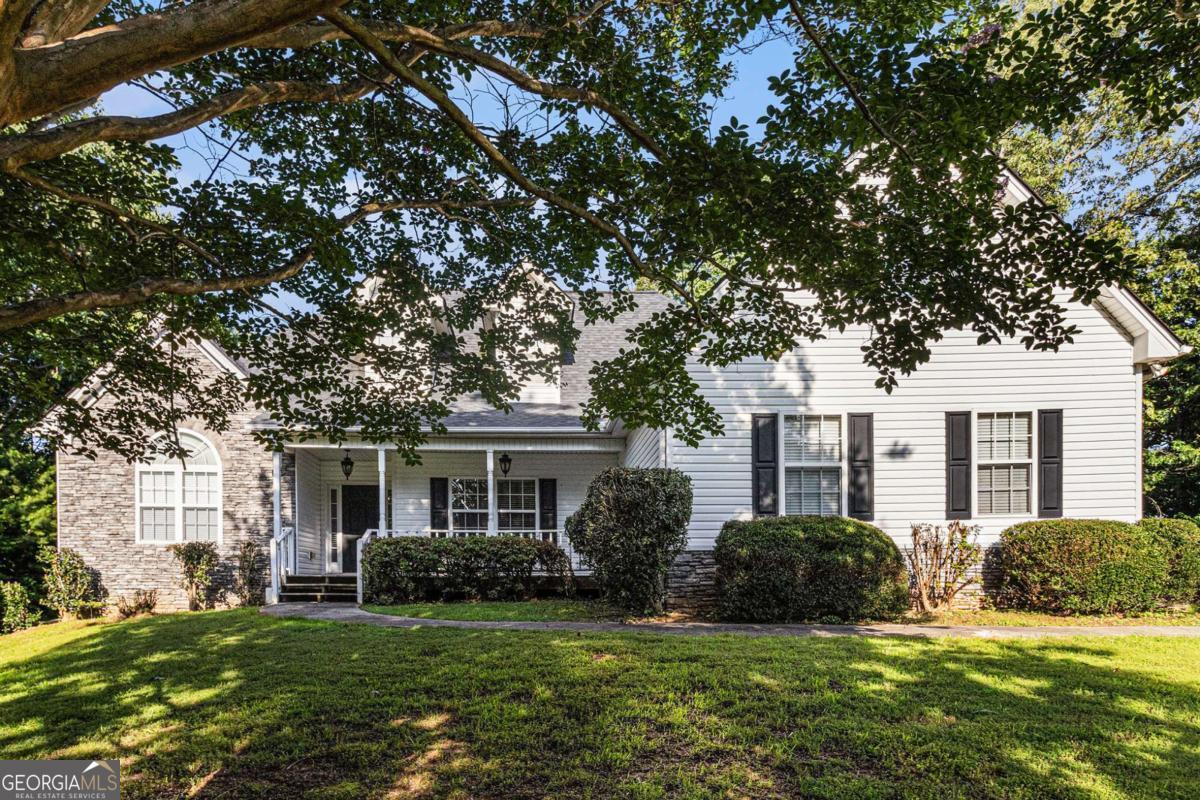 Located in a quiet subdivision with no HOA, this spacious home in Gainesville, GA sits on 2.93 acres and offers both comfort and privacy-just minutes from Hwy 60, Price Rd, shopping, and dining. The home features 3 generously sized bedrooms and 3 full bathrooms, with all bedrooms and two baths conveniently located on the main level. The primary ensuite includes a double separate vanity, soaking tub, and a walk-in closet. The open-concept layout seamlessly connects the living room, kitchen, and breakfast area, creating a welcoming space for everyday living. A formal dining room with elegant double tray ceilings adds a touch of sophistication. A walk-in laundry room is located just off the kitchen for added convenience. The upper level features a spacious bonus room, while the unfinished basement includes a finished full bathroom with a tub/shower combo-offering flexible potential for future customization. Enjoy peaceful outdoor living on the rocking chair front porch, raised wood deck, or in the expansive greenspace behind the home. Additional highlights include a two-car garage with side entry, wood-burning fireplace compatible with gas logs, new HVAC system (2022), and roof replaced in 2017. With ample space between neighbors, abundant storage, and easy access to nearby amenities, this home offers a perfect blend of privacy, functionality, and charm. Discounted rate options and no lender fee future refinancing may be available for qualified buyers of this home.