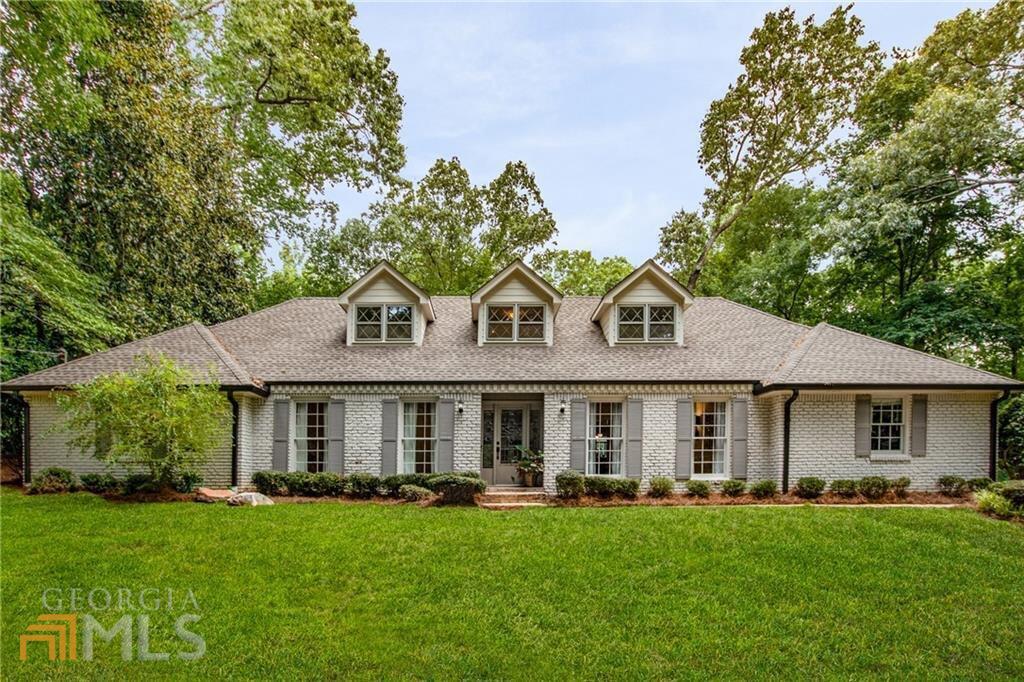 The Sandy Springs rental of your dreams is here! This elegant brick ranch sits atop a private acre lot w/4 bedrooms, 2 bath + 1 half bath on full basement. Gorgeous stone and hardwood flooring throughout the open concept main level. Kitchen features quartz countertops, stainless appliances and is adjacent to the fireside living room. Additionally the fireside living room leads out to an amazing covered deck. Convenient primary bedroom on the main level w/full bathroom featuring his/her vanity as well as seperate soaking tub & shower. Upstairs are three spacious secondary bedrooms and the second full bath. The basement provides ample storage and offers a finished bonus room that leads out to the back yard. Fully equipped laundry room on main level w/washer & dryer. Enjoy nearby amenities like Mark Trail Swim/Tennis , Lost Corner Nature Preserve, Spalding Dr Elementary, Abernathy Greenway and the newly finished City Springs! Available immediately.