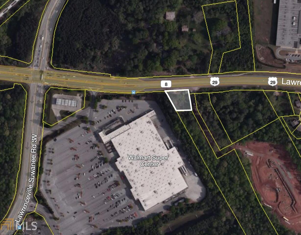 POTENTIAL COMMERCIAL! Great investment in a growing area of Gwinnett County. 163ft of road frontage on busy 4-lane highway next to Walmart. Perfect spot for a small business/office. Level Lot! All utilities available.