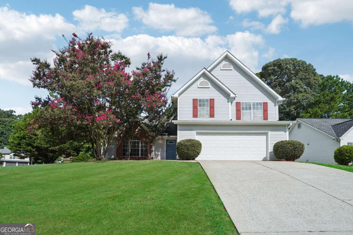 Welcome to this beautifully maintained 4-bedroom, 3-bathroom home nestled in a sought-after school district! Step inside to discover an open-concept living and dining area that flows effortlessly into a bright, modern kitchen featuring white cabinetry and brand-new stainless steel appliances-perfect for entertaining or everyday living. Enjoy the convenience of a full bedroom and bathroom on the main level, ideal for guests or multi-generational living. Outside, the beautifully landscaped yard offers a serene retreat and great curb appeal. Located just minutes from shopping, dining, and entertainment, this home offers the perfect blend of comfort and convenience. Don't miss your opportunity to make it yours!