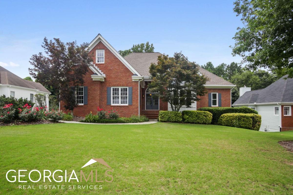 BEAUTIFUL EXECUTIVE RANCH HOME in Lawrenceville with 7 bedrooms and 3.5 baths. This is one of the largest floor plans in the coveted CThe Falls at North CliffC community. Once you enter this stunning Move-In-Ready home you notice the gorgeous, refinished hardwood floors and new carpet throughout the main level, the all-new interior paint and the natural light flooding your future home. The Heart of this home is the open concept kitchen, breakfast area and cozy vaulted ceiling Keeping Room with fireplace perfect for your morning coffee, family gatherings and entertaining. The spacious kitchen features a new Stainless Steel Gas Range with Cooktop, Granite Counters, Ample Cabinets with Pull Out Shelves for easy access to all your cooking utensils. From the Keeping Room you also have access to the spacious covered porch overlooking your private backyard which is ideal for a garden, corn hole, a play set or a fire pit. Adjacent to the kitchen through French Doors is the spacious formal dining room for 12+ guests. Adjacent to the Dining room in this open concept you will find the spacious living room featuring the second fireplace and French Doors leading out to your covered porch. On this main level you will also find the spacious Master suite and 2 additional bedrooms. The Master Suite features a high double tray ceiling and a completely updated Private Ensuite SPA Bath with a spacious his/her closet, new Soft Close double vanities, freshly updated separate shower, water closet and new Gorgeous Free Standing Soaking Tub. Spacious secondary bedrooms 1 & 2 on the main level share a full Jack & Jill bathroom. For those working from home who need a private office to work from, you will find a spacious office up the freshly carpeted steps in the kitchen to the 2nd floor space above the garage with its own AC unit. And for those who need more bedrooms than the standard 3, take the stairs down to the finished terrace level with 4 additional bathrooms (yes that makes 7 in total) plus a full bath and spacious gathering space for movie night or teen hangout. Floating Luxury Vinyl Flooring covers the entire terrace level. With this many bedrooms you will be thrilled with your Rinnai Tankless Water heater with its endless supply of hot water. And for the gardener in the family, simply exit the terrace level though your French doors through your covered patio to your established garden which is calling you to nurture the abundance of fruit trees/plants (pecan, pear, fig, hardy lemon, pomegranate, strawberries, and blueberries) and herbs (Oregano, Sage, Rosemary & Dill) growing in your new yard. And for you flower gardeners you have a multitude or perennials waiting to delight you each year. The Falls at North Cliff community has an active HOA with a pool, clubhouse, & tennis courts. You'll be just minutes from Downtown Lawrenceville Square, the Shoppes at Webb Gin House, & 700 Acre Tribble Mill Park, as well as the award-winning Archer School cluster. Don't miss out on the opportunity to own a piece of this exceptional community. Schedule your private tour today and fall in love with your future home!