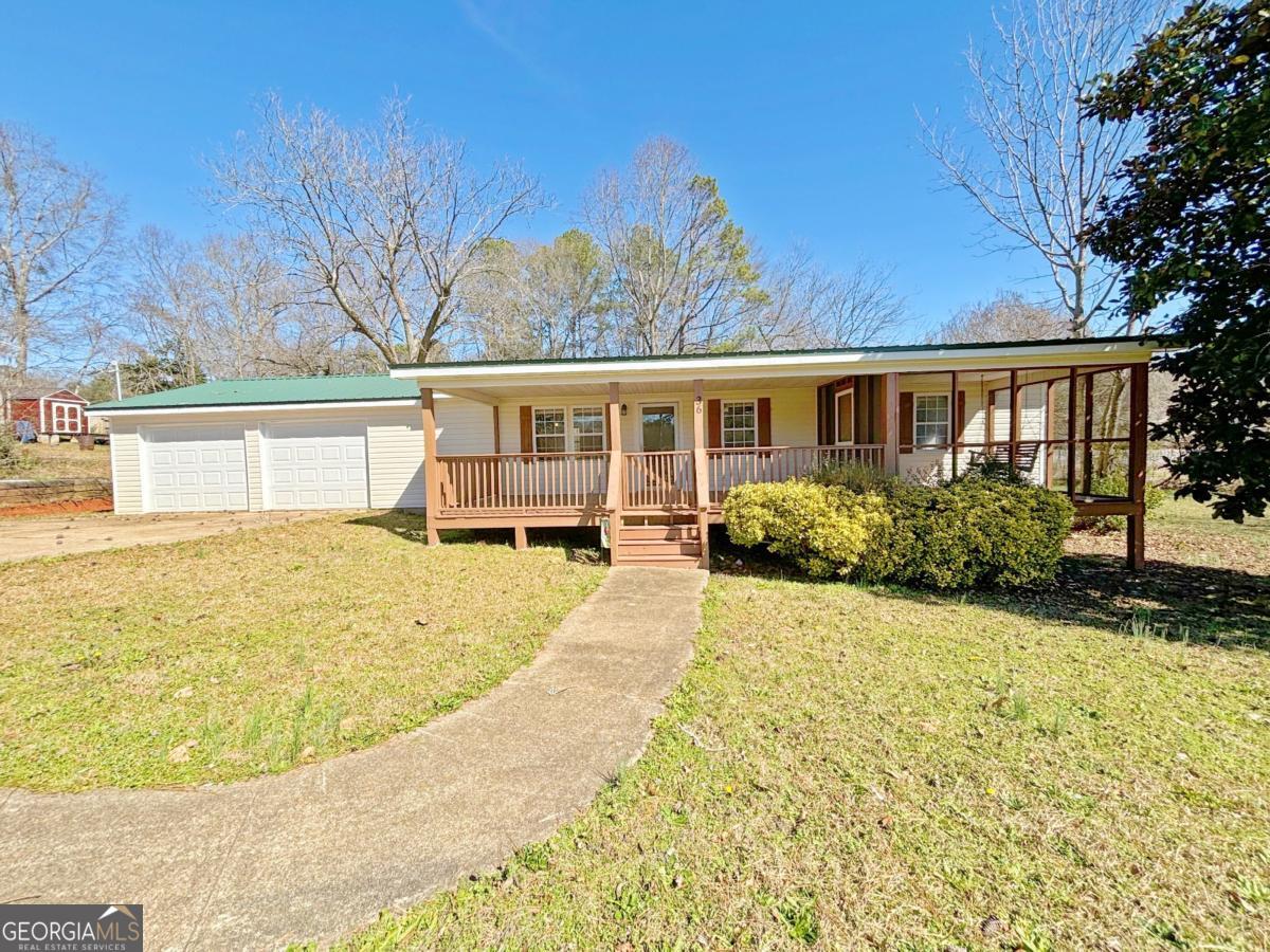 Your new home awaits! Located just 20 minutes from downtown Newnan, this 3-bedroom, 2-bathroom property offers a blend of comfort and convenience. Step inside to an open floor plan that seamlessly connects the family room and kitchen - perfect for entertaining. Recent upgrades include a brand-new metal roof, a new HVAC system, new vinyl siding and an updated front covered deck with a screened-in section for year-round enjoyment. Plus, a spacious 2-car garage and plenty of privacy make this home a must see. Schedule your showing today!