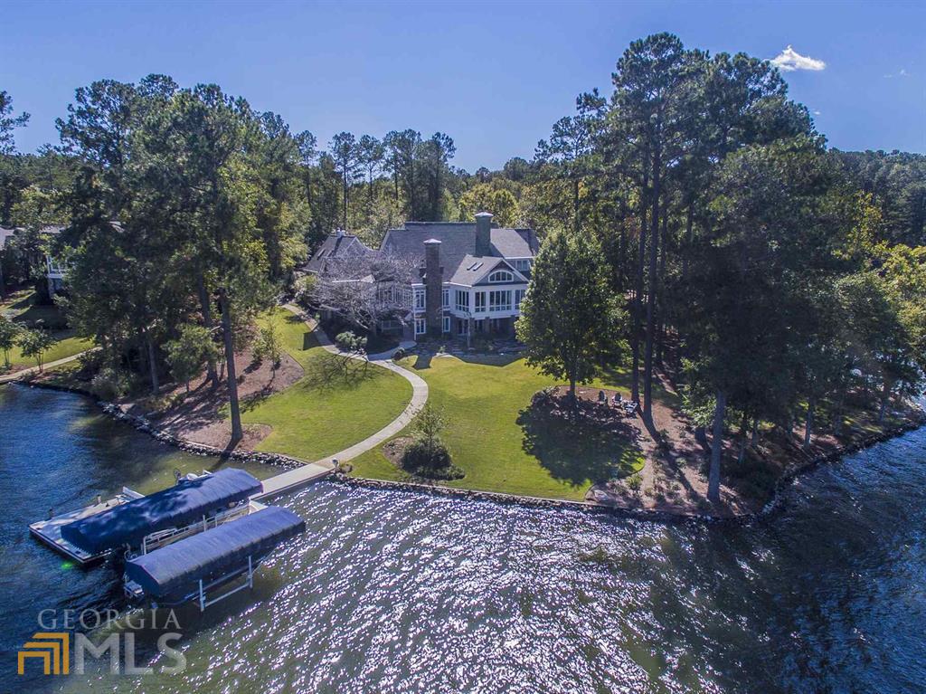 Escape to this Lake Country Retreat and enjoy this rare opportunity to "Live the Dream" on a point lot on the shores of Lake Oconee in the heart of Reynolds! All of the renovations and updates allow this immaculate home to show like a timeless model home! From the moment you stroll through the front courtyard and enter the soaring two-story foyer, you will feel the state of the art conveniences and the luxurious finishes that you expect to find in a home of this caliber. Your family and friends will enjoy world class lake views from nearly every room along with stunning sunsets and sunrises. Main features include open floorplan, point lot, multiple stone fireplaces, cedar screened porch, vaulted ceilings, rustic beams, granite countertops, Butler's pantry, top of the line appliances and private baths for each bedroom...too many upgrades to list. Golf Membership is available.