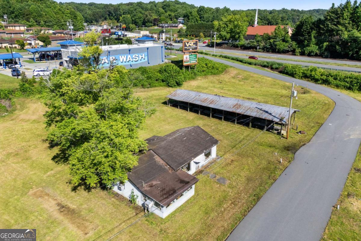 PRIME COMMERCIAL OPPORTUNITY IN MURPHY, NC! Unlock exceptional investment potential with rare commercial property located within the city limits of Murphy, North Carolina! Surrounded by high-traffic neighbors including McDonald's, Subway, a busy gas station, and a brand new car wash connected to the property. This location is a true hotspot.The property includes: Existing Commercial Building- Ideal for turnkey business or office space. Fixer Upper Home- Brimming with potential for rental income or resale. There are two billboards that are leased out on the property to Allison Signs for additional monthly income.Massive Storage Facility- Perfect for storing RVs, boats, or vehicles. Flat, Usable Acreage- A rarity in the Murphy market. City water and sewer are readily available, running the backside of the property. Enjoy unique privacy with TVA and Forest Service land bordering the rear, just steps from the scenic Hiwassee River Additional perks include: Private paved road winding through the property and connecting back to Hiwassee St. Traffic count averaging 18,000-21,000 vehicles per day! unbeatable exposure! Only half a mile from Historic Downtown Murphy, with boutique shops and fine dining. Minutes from the Cherokee Valley River Casino. Whether you're looking to expand a business, develop rental units, or invest in one of Murphy's most promising commercial zones, this is the one you've been waiting for. Opportunities like this don't come around often- Schedule your showing today!