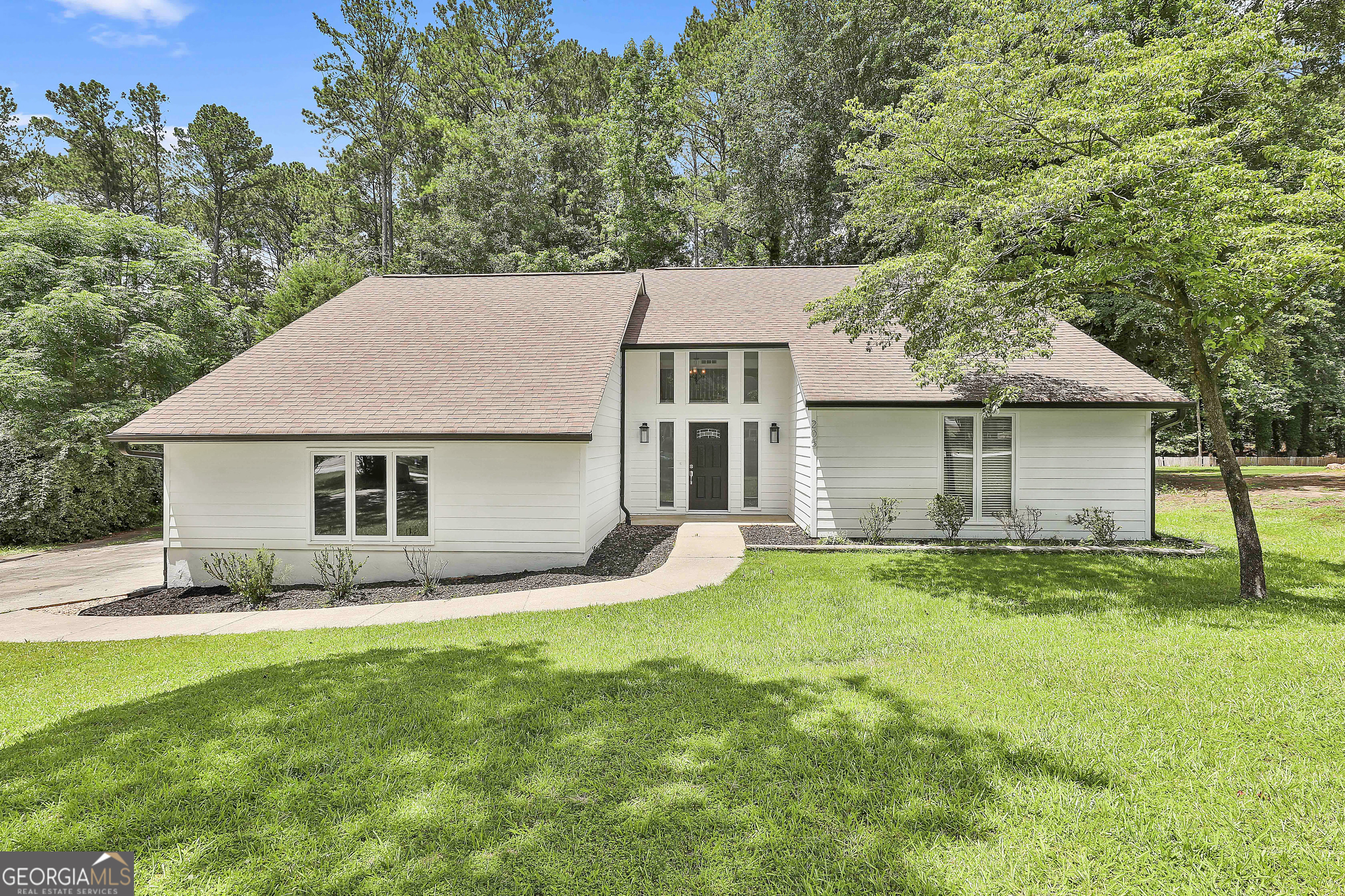 Come see this beautifully renovated 4-bedroom, 2.5-bath home featuring a spacious bonus room, perfectly situated in the heart of Peachtree City. Enjoy over 100 miles of scenic golf cart paths and easy access to shopping, dining, and outdoor recreation. The exterior and interior have been freshly painted, creating a clean and updated look. Step through the front door into a grand two-story foyer and onto brand-new luxury vinyl plank flooring that flows throughout the main level, with elegant tile in all bathrooms. Stylish new lighting fixtures and hardware have been installed throughout the home. The open-concept kitchen features sparkling white quartz countertops, ample cabinet space, a large eat-in dining area, and brand-new stainless steel LG appliances. Upstairs, you'll find new carpet in all bedrooms, while the oversized bonus room showcases beautiful hardwood flooring and a built-in wet bar-perfect for entertaining or a flexible living space. In the great room, a striking floor-to-ceiling stone fireplace with a raised hearth and wood mantel is complemented by a large clerestory window and a wide double-panel sliding glass door that opens onto a huge screened-in back porch. This porch overlooks a private, wooded backyard with a brand-new deck and a large custom fire pit-ideal for gatherings and relaxing evenings. The backyard also includes a custom-built RV/boat carport with an attached two-story storage building, offering endless utility and space. Schedule your private tour today.