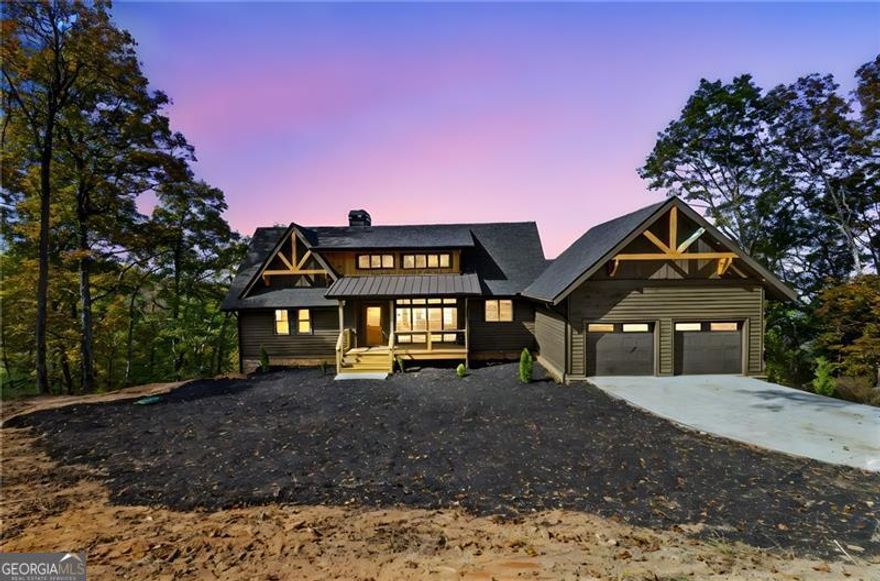 Just completed! This brand-new 4 BR / 4.5 BATH mountain home sits on over 8 private acres with long-range panoramic views from every vantage point. From the moment you arrive, the rocking chair front porch and level concrete driveway welcome you to a home that blends rustic charm with modern design. Inside, the open layout features soaring wood-beamed ceilings, a dramatic floor-to-ceiling stacked stone fireplace, and wide-plank hardwood floors throughout the main level. Natural light pours into every space, highlighting the home's thoughtful finishes and warm textures. The bedroom layout is ideal: the primary suite is located on the main level, offering stunning views and a spa-like bath. A second private suite is located upstairs above the garage with interior access-perfect for guests or extended stays. On the terrace level, you'll find two additional bedroom suites, each with direct access to full bathrooms, offering privacy and comfort for all. Two full-length covered decks-one on the main level and one on the terrace-let you take in the sweeping mountain views from sunrise to sunset. Tastefully designed and move-in ready, this is a true mountain retreat just minutes from Jasper's shops, wineries, and scenic hiking trails. Every inch of this home was built to bring the outdoors in-and give you a front-row seat to the North Georgia mountains.