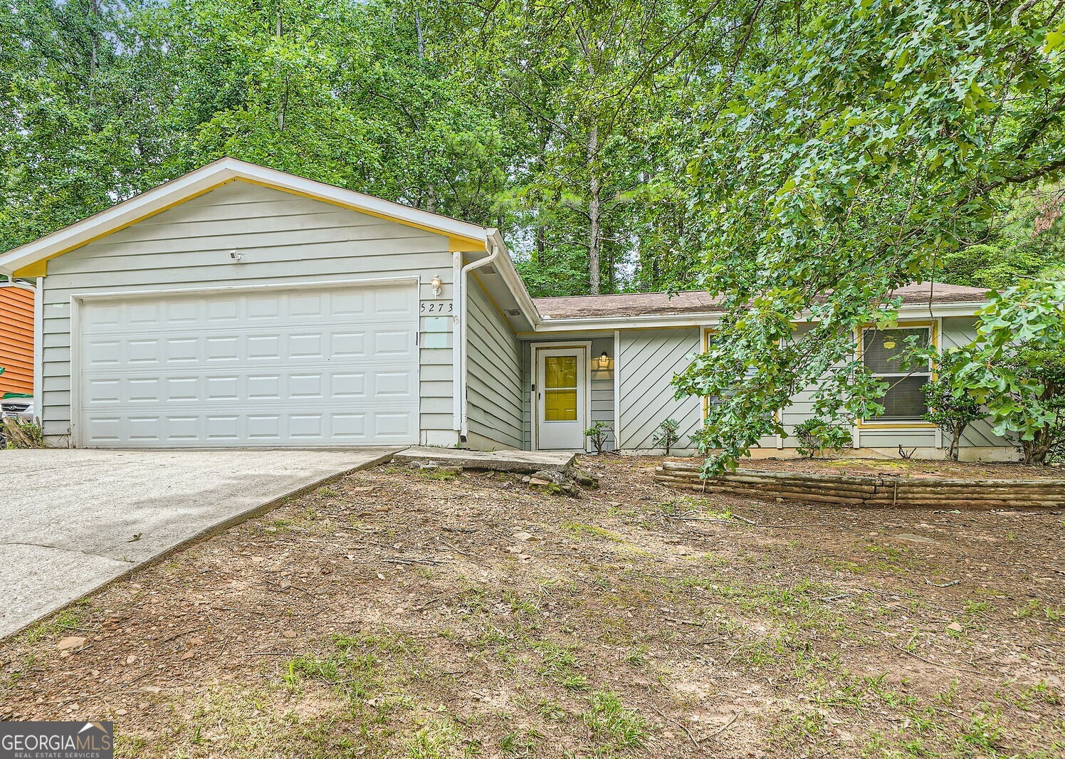 Welcome to 5273 Martins Crossing Rd - a charming and affordable 3-bedroom, 2-bathroom ranch-style home nestled in a quiet, wooded neighborhood in Stone Mountain! This move-in-ready gem features a spacious living room with vaulted ceilings, a cozy stone fireplace, and large sliding glass doors that fill the space with natural light and open to a private, wooded backyard. The galley-style kitchen includes stainless steel appliances, tile flooring, and plenty of cabinet space. The oversized primary suite boasts an en-suite bathroom with updated finishes, while two additional bedrooms share a second full bath with modern tile work. Additional highlights include an indoor laundry area, a 2-car garage, and a low-maintenance yard - perfect for first-time buyers, investors, or anyone looking to downsize. Conveniently located just minutes from Stone Mountain Park, shopping along Highway 78, and with easy access to Atlanta via I-85 and Hwy 78, this home blends comfort, value, and location. Don't miss your chance to own in a well-established neighborhood with no HOA! Property is tenant-occupied through the end of August. Please do not disturb tenants. Showings by appointment only.