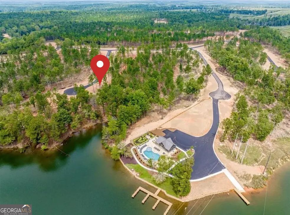 Don't miss this incredible opportunity to own a piece of paradise in The Falls at Rocky Creek, one of Milledgeville's newest lakefront communities. Build your dream home on this 1.05-acre lot and start living the lakeside lifestyle you've always envisioned. This gated community is situated on the pristine shores of Lake Sinclair and offers natural beauty and luxurious amenities. The amenities include a lakefront park with a Pavilion, a resort-style pool, a boat ramp, boat slips and storage, miniature golf, and an outdoor workout area. Lake Sinclair is a highly sought-after destination due to having one of the clearest lakes in Georgia, a wide range of water activities, and excellent fishing opportunities. Act now and secure your place in this exclusive community. Seller is a licensed real estate agent in GA.