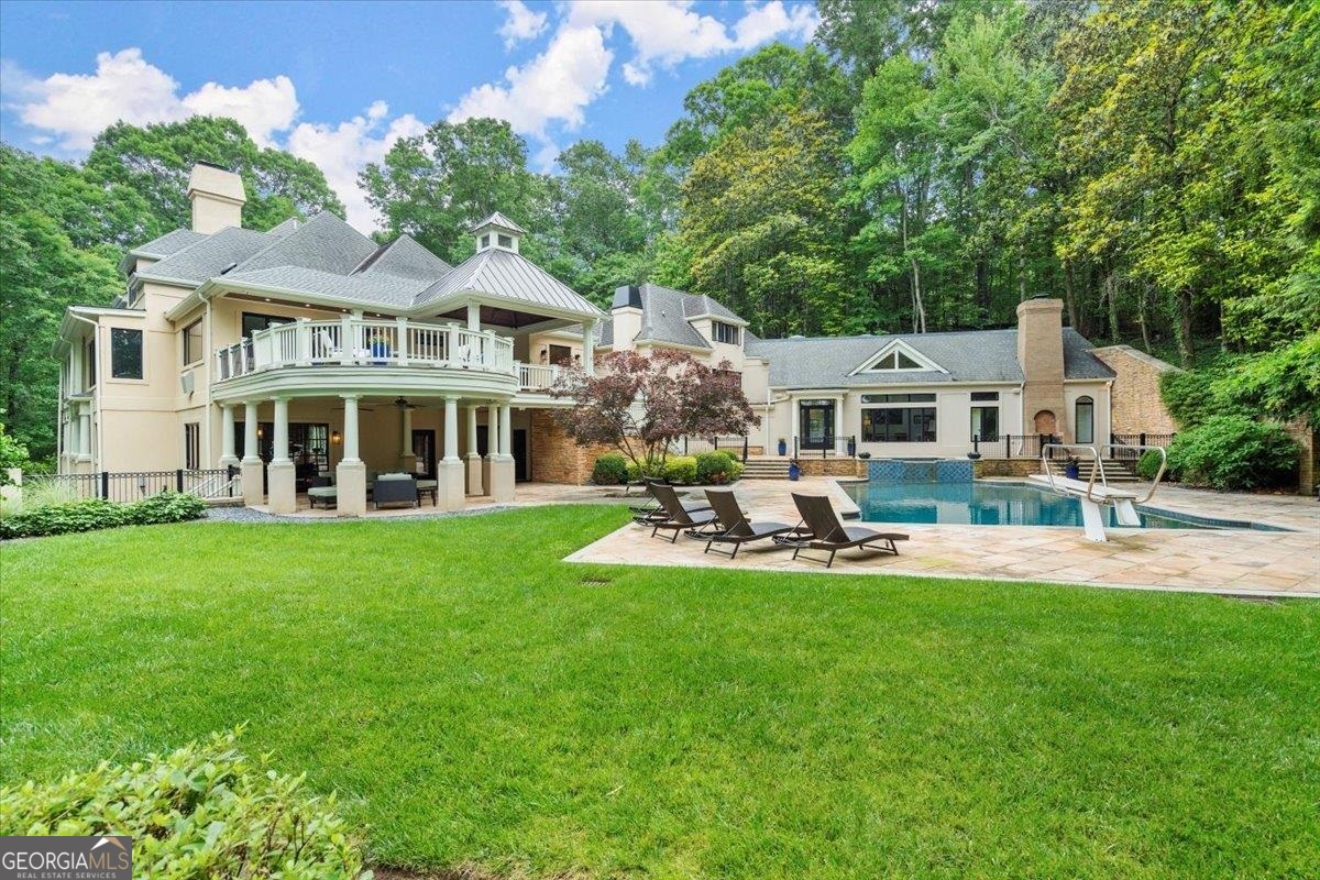 Serene riverfront estate, +/- 3.94 wooded acres, overlooking the Chattahoochee River and Cochran Shoals National Park. With sweeping seasonal views, the home itself is only matched by the beauty of its natural surroundings. A level driveway brings you to a private front entrance. Once inside, you'll find the open floor plan flows effortlessly, while custom windows & doors accentuate the natural surroundings. Detailed upgrades on the main floor include: spacious living room with custom, concrete mantle, large formal dining room, expanded Chef's kitchen with quartzite countertops, custom cabinets, & expansive island. Thermador & Bosch appliances. The primary suite offers fireplace, spacious steam shower, free standing soaking tub, walk-in closet & access to balcony. This spectacular home affords you numerous opportunities to have fun, while still escaping the hustle & bustle of the outside world. Features include: numerous decks, patios & balconies, a 12 ft deep, 66,000 gallon in ground salt water pool with adjoining pool house, & your very own launching pad to canoe/kayak the Chattahoochee River! On the terrace level you'll find: fireside gathering room, gym, bar, wine cellar, vault, bed/bath, and a two-bedroom apartment with kitchenette & separate entrance. On the top level, three en-suite bedrooms (2 fun secret areas) 3 car garage. State of the art security system. Impeccable sellers with unbelievable maintenance. Ideal for multi-generational living. Seller will consider selling the house fully furnished minus a few personal items. As such, the property would make a lovely, turnkey second home or, with the potential to rent it for over $20,000/ month, a luxury rental property for a savvy investor.