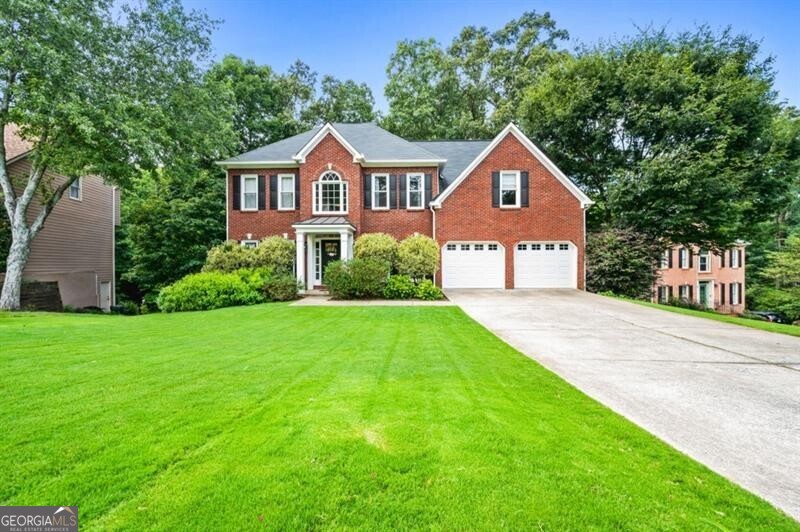 Welcome to this beautifully updated traditional home featuring 5 bedrooms, 4.5 bathrooms, and three spacious levels of living. From the moment you arrive, the flat driveway and charming curb appeal set the tone for a warm and inviting home that blends modern updates with timeless style. Inside, gleaming hardwood floors flow throughout both the main and upper levels. The updated kitchen showcases white cabinetry, granite countertops, a tiled backsplash, a built-in pantry cabinet, an oversized island, and a sunny eat-in breakfast area-perfect for everyday living and entertaining. The freshly painted dining room features stylish shiplap detail, while the open-concept family room connects seamlessly to the kitchen. At the front of the home, a versatile flex space can serve as a home office, playroom, or cozy sitting area. A beautifully updated half bath completes the main level. Upstairs, the oversized primary suite includes a cozy sitting area, creating a true retreat. Two generously sized guest bedrooms share a well-appointed hall bath, while a fourth upstairs bedroom features its own ensuite bath and a spacious walk-in closet. Step outside to enjoy two expansive decks-one off the main level and another below-perfect for entertaining or relaxing in the hot tub. The backyard is serene and private, backing to a peaceful creek, with the property line extending beyond. An impressive list of upgrades sets this home apart in its price category.