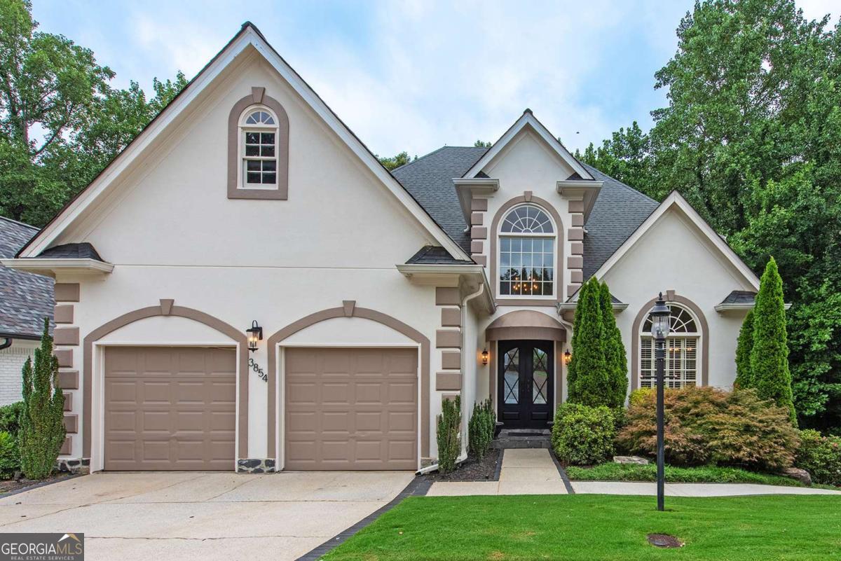This meticulously maintained European-style home is quietly tucked away on a private cul-de-sac in one of Brookhaven's most desirable neighborhoods. Freshly painted inside and out in designer neutral tones, the property is move-in ready and offers a rare combination of privacy, space, and convenience. The main level features soaring ceilings, a light-filled layout, and an open-concept design ideal for everyday living or entertaining. The gourmet kitchen includes high-end appliances, granite and slate finishes, and rich maple cabinetry-flowing seamlessly into the living and dining areas. The spacious primary suite is a true retreat with a spa-like bath, beautifully remodeled to include modern finishes. All bathrooms throughout the home have been thoughtfully updated, blending contemporary style with timeless design. Downstairs, the terrace level offers a full second living space with its own private entrance and walkway. Complete with a second kitchen, great room, office, two bedrooms, a bonus room, and a full bath, it's perfect for in-laws, teens, roommates, or short-term rental opportunities. The expansive back deck overlooks a peaceful, wooded yard and is perfect for relaxing or hosting guests. Recent mechanical upgrades provide comfort and efficiency for years to come. Set in a quiet community with sidewalks and minimal HOA, this home is just minutes from parks, premier shopping, top-rated Atlanta restaurants, and major conveniences-offering the perfect blend of nature and city access.