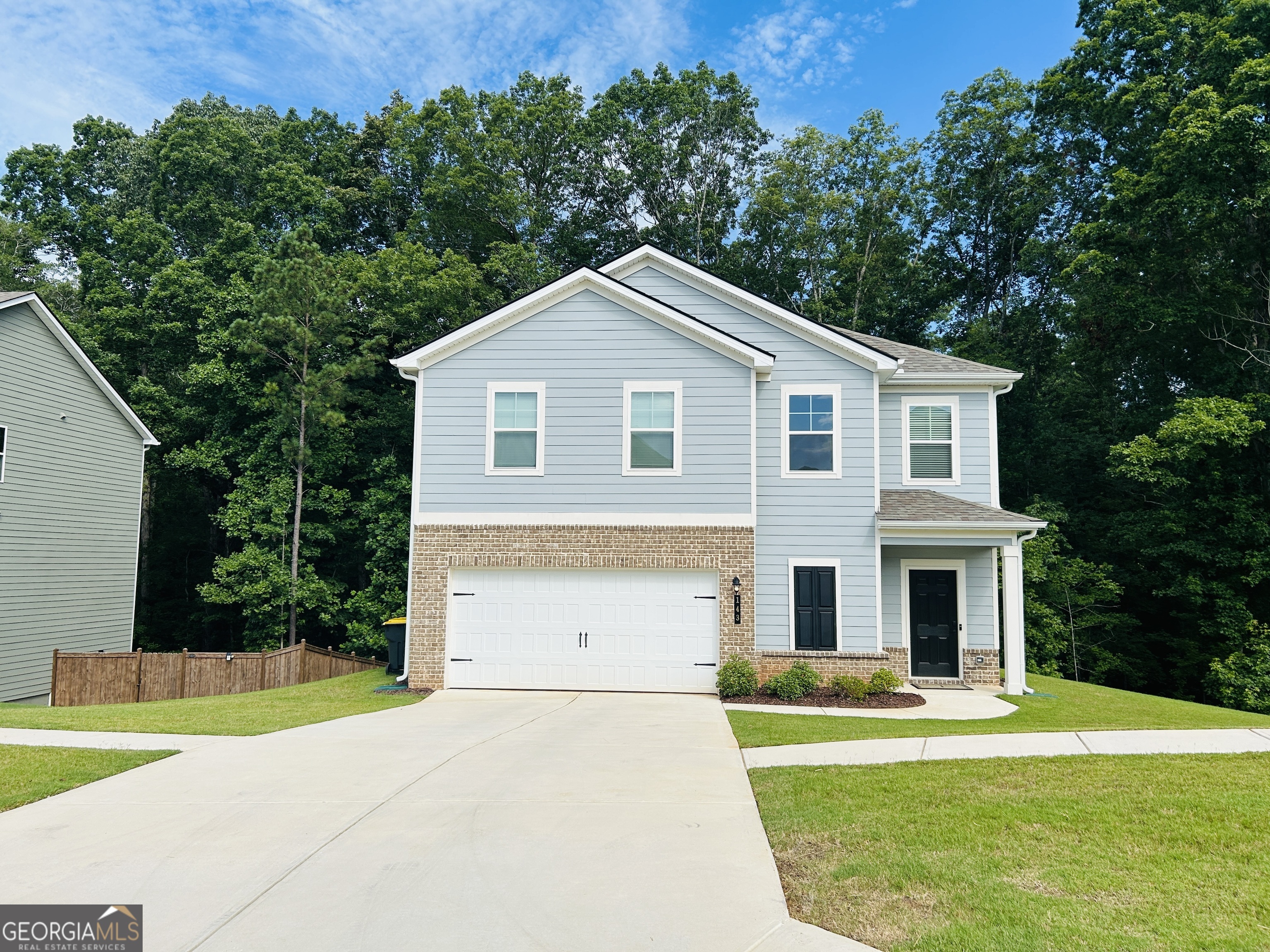 Welcome home to this 2 year old, 3 bedroom 2.5 bathroom home in one of Newnan's newest communities! This home features an open concept with tons of natural light and space! The kitchen has stunning quartz countertops and all SS appliances and looks directly into the family room. The beautiful modern fireplace adds a nice touch to this home! As you enter the home you are welcomed by the formal living and dining room with breathtaking floors! Upstairs you will find the oversized primary suite with a large walk in closet, dual sink vanity, soaking tub and separate shower. The secondary bedrooms, second full bathroom, open bonus area and the laundry room are all conveniently located upstairs! This home is located close to the communities pool, mailboxes and playground. Minutes from Downtown Newnan, shopping, restaurants, I85 and more! This one is truly a must see!