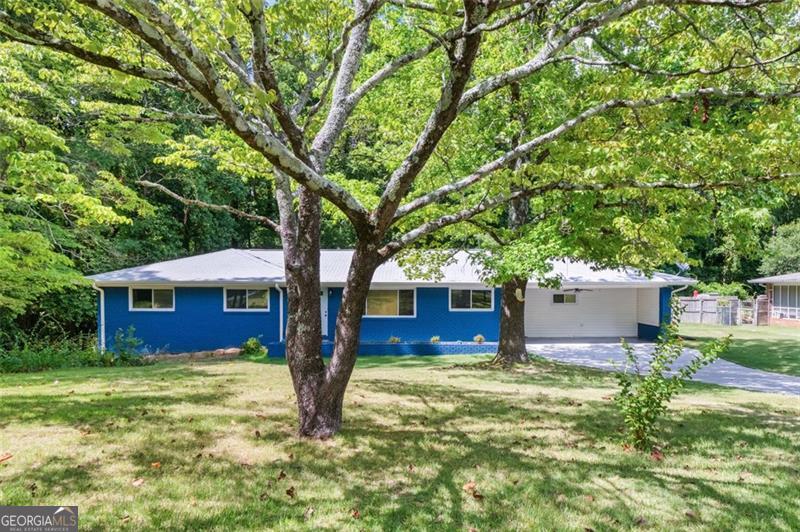Welcome to this completely remodeled 4-bedroom, 4 FULL bathroom ranch-style home with a fully finished basement suite, offering over 3,400 sq ft of living space on a .27-acre lot in a quiet neighborhood, conveniently located right off of I-75. Every inch of this home has been thoughtfully upgraded for peace of mind and modern comfort: *NEW* electrical wiring throughout home, *NEW* electrical panel, *NEW* stainless steel appliances, *NEW* water heater, *NEW* cabinets with quartz countertops in the kitchen, *NEW* deck, *NEWER* HVAC system, *NEWER* roof, *Completely waterproofed* basement from the exterior, with water redirected away from the home-includes 10-year transferable guarantee. Step into an open-concept main level with beautiful original hardwood floors, spacious living and dining areas, and a chef's kitchen designed to impress. The primary suite features a luxurious soaking tub, double vanity, and generous layout. Two of the four bedrooms have en-suite bathrooms, offering ultimate privacy and convenience for guests or family members. The basement level doubles as a full apartment suite complete with its own bedroom, bathroom, living space, and exterior exit-perfect for multigenerational living, guests, or rental potential. Enjoy outdoor living in the clear, level backyard, easily accessible from the mudroom that leads to the back deck. A mini carport area includes additional storage space, making organization simple. With each bedroom offering its own bathroom, a bright and open layout, and major system upgrades already completed, this move-in ready gem delivers both comfort and long-term value in an unbeatable location.