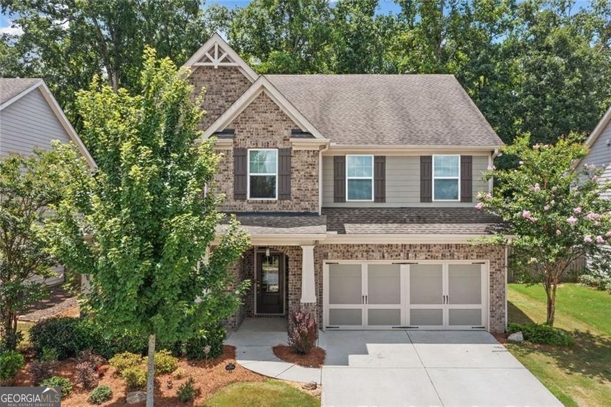 Get a 1/0 rate buy-down for the first year using the Seller's preferred lender! Hurry and move right in to this this better-than-new home and experience North Georgia's colors of fall in your own backyard.  Relax in your private spa on those crisp fall nights.  Enjoy the brisk cool air while you stroll around the desirable Gardens of Harmony neighborhood, which is known for exceptional amenities and lifestyle appeal. From the moment you arrive, the curb appeal and thoughtful design set the tone for what's inside.  Step into the oversized dining room, perfect for hosting gatherings and holiday meals. The bright white kitchen has a large island with pendant lights. It includes a gas cooktop, built-in oven, and microwave. Also, there's a sunny eat-in area that flows into the living room. Enjoy cozy evenings by the gas fireplace surrounded by custom built-in bookshelves.  The main level offers a guest suite with a full bath, ideal for visitors or multigenerational living. Hardwood floors throughout the main level add warmth and style.  Upstairs, there's a flexible loft great for gaming, working, or relaxing. You'll also find three good-sized bedrooms, and a full bath. The roomy primary suite boasts a double trey ceiling. It includes a large walk-in closet and a lovely en suite bath. The bath features a soaking tub, a tiled shower, and double vanities.  Step outside to your private retreat. The covered patio looks out over a fenced backyard oasis. It has a fire pit, a hot tub with a waterfall, and a sparkling saltwater in-ground pool.  A two-car garage with kitchen level entry completes the package.  This home truly has it all-space, style and resort-level outdoor living in a vibrant neighborhood setting to compliment a freshly painted interior, brand new carpets, and refinished hardwood floors for a home that's truly move in ready.