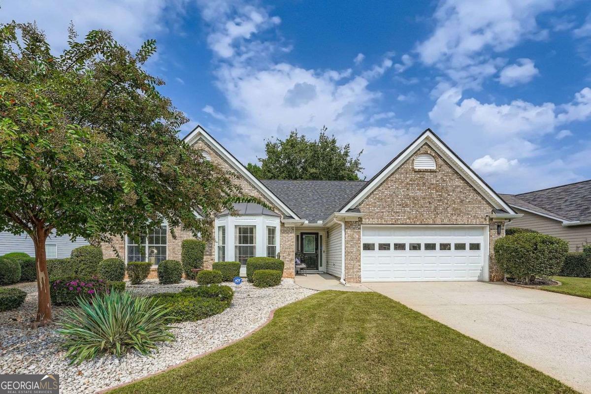 Welcome to this impeccably clean and beautifully maintained one-level ranch in Browning Chase, one of Tucker's most popular and welcoming communities. From the moment you arrive, you'll notice the pride of ownership and thoughtful care that has gone into every detail of this home. Recent updates include a newer HVAC system, roof, and water heater, giving peace of mind for years to come. The expansive family room offers vaulted ceilings and a cozy gas fireplace, creating a warm and inviting space to gather. The oversized primary bedroom with soaring ceilings features a spa-like bath with a soaking tub and separate shower, while the secondary bedrooms are filled with natural light from elegant Palladian windows. The bright white kitchen with island and cheerful breakfast area is spotless and ready for both everyday meals and entertaining. A sunroom provides extra space to enjoy the natural light and backyard views year-round. Outside, the fenced backyard is a true highlight with a patio, awning, arbor, lush gardens, and mature plantings that create a private retreat. The front yard is landscaped for low maintenance and includes an irrigation system, making upkeep simple. Set in a peaceful neighborhood with sidewalks where neighbors stroll daily, this home is just minutes from downtown Tucker's wonderful restaurants, shopping, and community events. Experience easy, single-level living in a home that has been cared for with exceptional attention.
