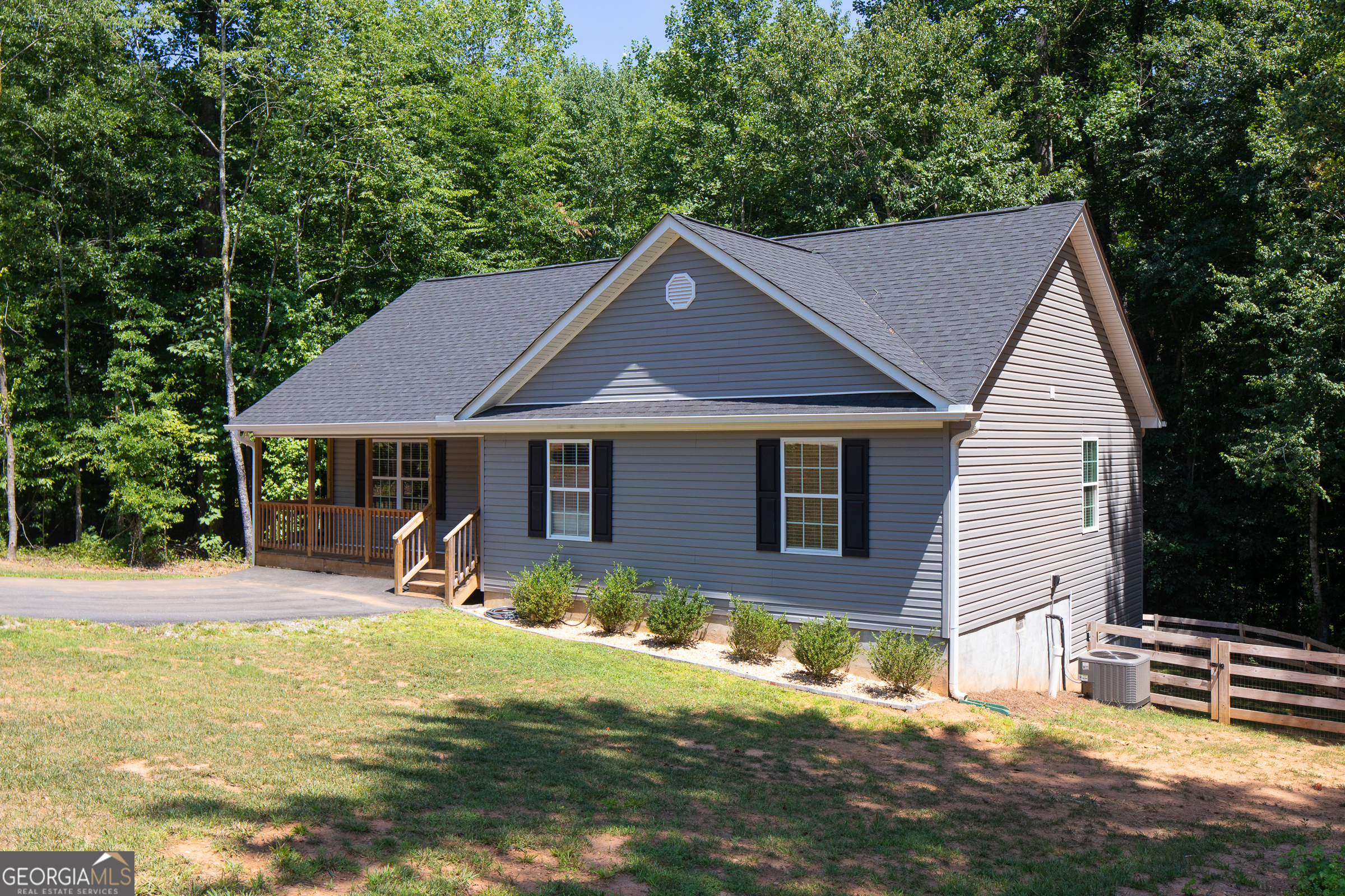 Don't miss out on this home that is still like brand new! Soaring ceilings greet you as you enter the house, lvp flooring throughout, open kitchen/living floor plan, granite tops-even in bathrooms. Owners have added covered back porch and fenced property ready for your pets and playtime! Conveniently located near Clermont, Cleveland, Dahlonega and easy access back to GA 400.