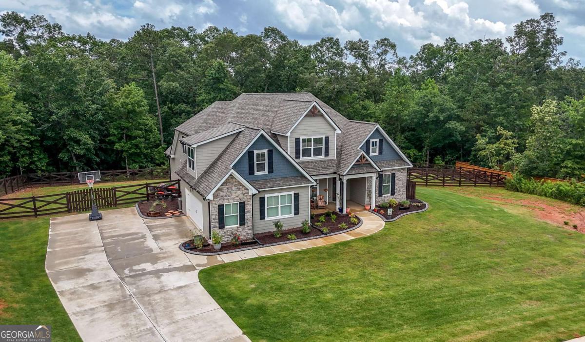 Say hello to this stunning, nearly-new construction home that effortlessly blends comfort, style, and functionality. Built in 2022 and meticulously maintained, this spacious residence offers over 2,900 square feet of thoughtfully designed living space, perfect for a growing family or anyone craving room to spread out and settle in. Inside, you'll find 4 generously sized bedrooms and 3.5 bathrooms, along with an open-concept layout that flows beautifully from the kitchen to the family room. The kitchen is a chef's dream, featuring stainless steel appliances, a large center island, recessed lighting, and charming ceiling beams that add warmth and character. Step outside and enjoy your private backyard oasis, complete with a modern barn-style fence that provides both openness and privacy - ideal for entertaining, relaxing, or adding your own personal touches. The owner's suite is a true retreat, featuring a spa-like ensuite with a garden tub, separate walk-in shower, and all the bells and whistles that make winding down feel like a luxury. With a 2-car garage, modern finishes, and plenty of natural light throughout, this home is truly a gem in the heart of Douglas. Don't miss the chance to make it yours!