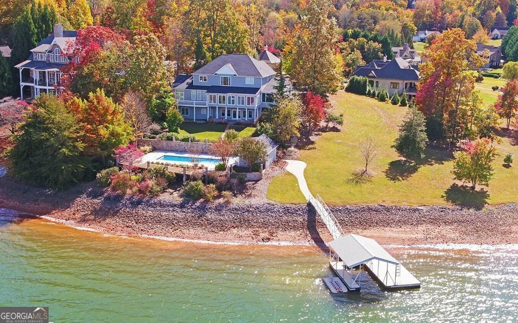 BIG VIEWS ** BIG VIEWS ** Located in a secluded location nestled with three other upscale homes. You will not find a better view on the lake. Sweeping views of the lake and surrounding mountains. The house has been thoughtfully upgraded by professional contractors. Professionally designed and furnished by top designers. Master suite has an attached yoga room or study. There are a total of 8 bedrooms and 6 baths, plus a pool house with its own full bath. Large, in-ground pool and surrounding decks and patios are perfect for outdoor entertaining. No expense has been spared on the landscaping and hardscapes. Brand new roof was installed two years ago. Year-round deep water! The house can be purchased furnished (excluding personal items and art) with an agreed on price, if so desired. Take one look at the view and property and you won't want to leave! See additional photos and tour at www.tour.vht.com/434431151/1951-island-view-rd-hiawassee-ga-30546/idx