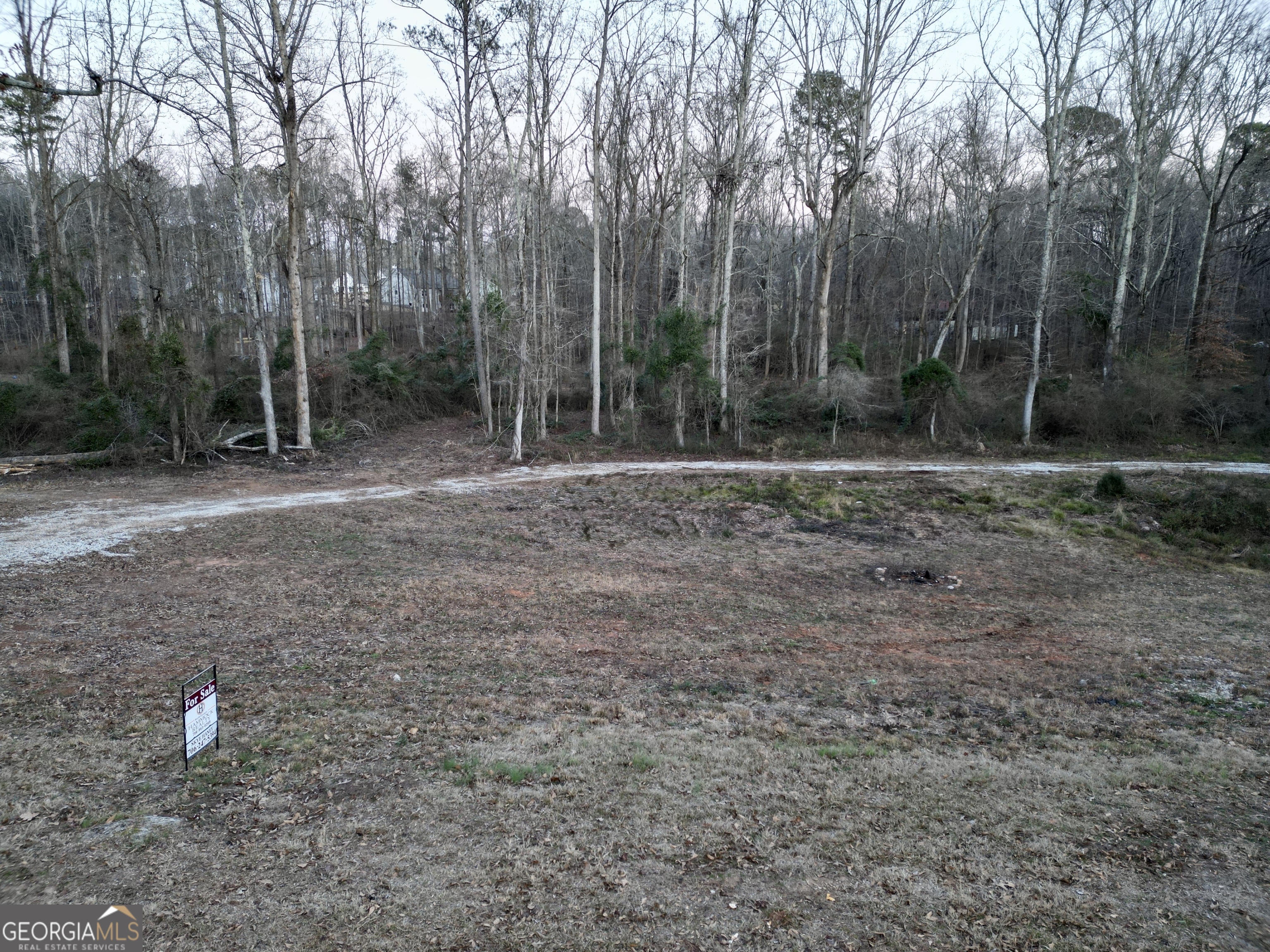 Owner is motivated to move this on to the next, don't miss your chance to own land while you can in Barrow County. This rare 11 acre tract in Bethlehem offers the perfect mix of natural beauty and practicality. With over 1400 feet of paved road frontage for easy access and a peaceful creek flowing through the property, it is an ideal spot for your dream home, farm, or recreational retreat. This property boasts an established driveway, making access to the property easy. The owner has recently installed a culvert and 2 bridges over Sugar Creek to access the back of the property as well. A septic perc test has already been completed, the groundwork is laid out for your plans to come to life. Enjoy the tranquility of country living while being conveniently close to local amenities, schools, and shopping. Do not miss this rare opportunity to own a versatile and picturesque property in a sought-after location. Schedule your showing today and bring your vision to life!