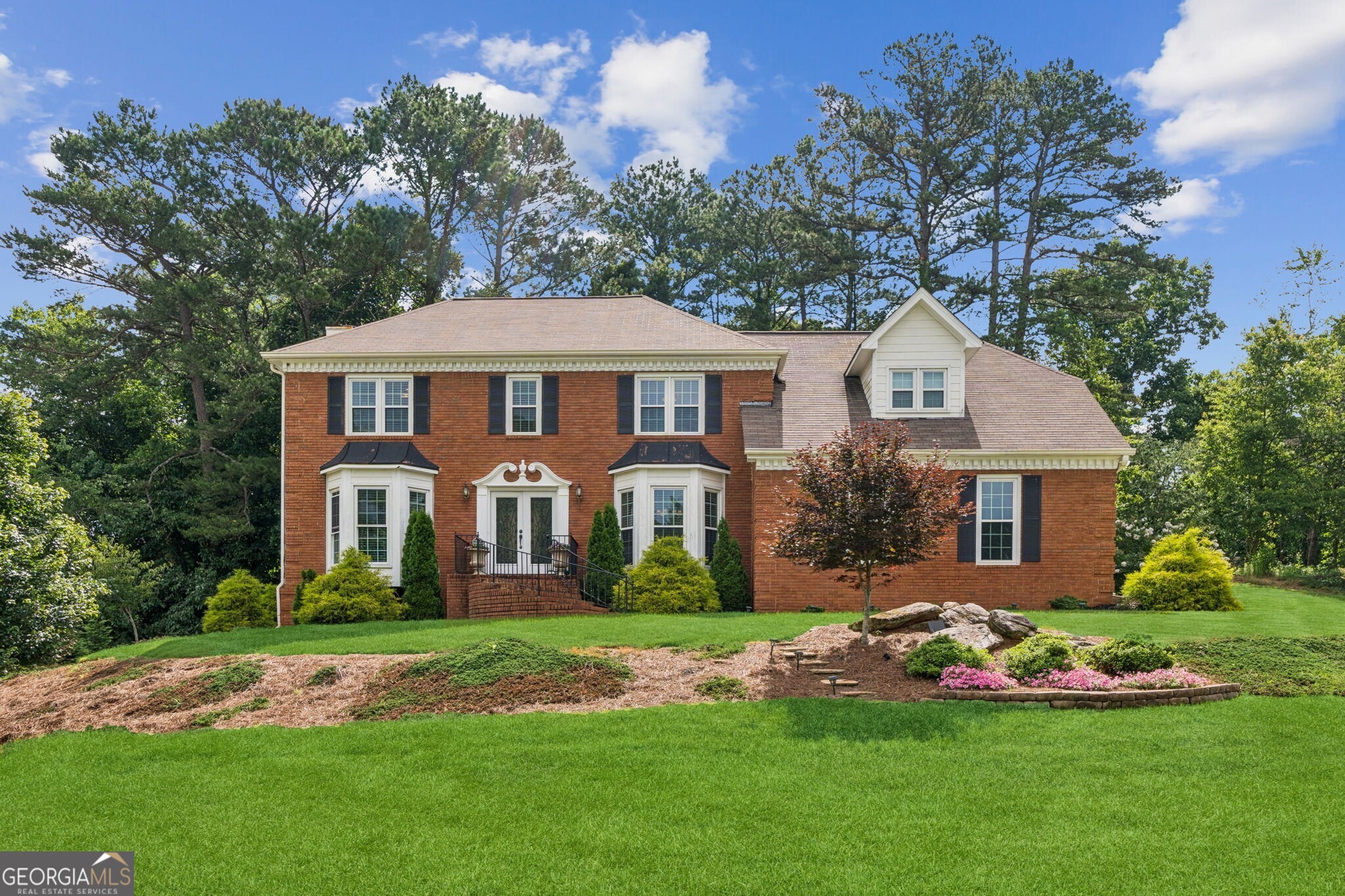 Introducing this stunning, remodeled, traditional home offering an ideal blend of style, functionality, and privacy. Located within walking distance of the Sugar Hill Corners Shopping Center and just minutes from Downtown Sugar Hill, Downtown Suwanee, and Historic Downtown Buford. The double front doors invite you into a foyer/entry way with an abundance of natural light and where the updates and modernizations become apparent in this clean and well-appointed home. The floorplan seamlessly connects the Spacious Family Room to the Kitchen featuring White Cabinets, Beautiful Brick Backsplash with Under-Cabinet Lighting, New Stainless-Steel Appliances, and White Farm Sink at a Window overlooking the Large Back Porch and Private Backyard. Upstairs you will find a Loft/Media Room and 3 Bedrooms including the Spacious Primary Suite with plenty of Sitting Room, Bath with Two Separate Vanities, Large Shower with Separate Garden Tub, and a Large Primary Closet with Custom Shelving. The Backyard is Private and Peaceful making it an awesome place for gatherings while taking in the natural beauty of the trees behind the home. Schedule your showing today!