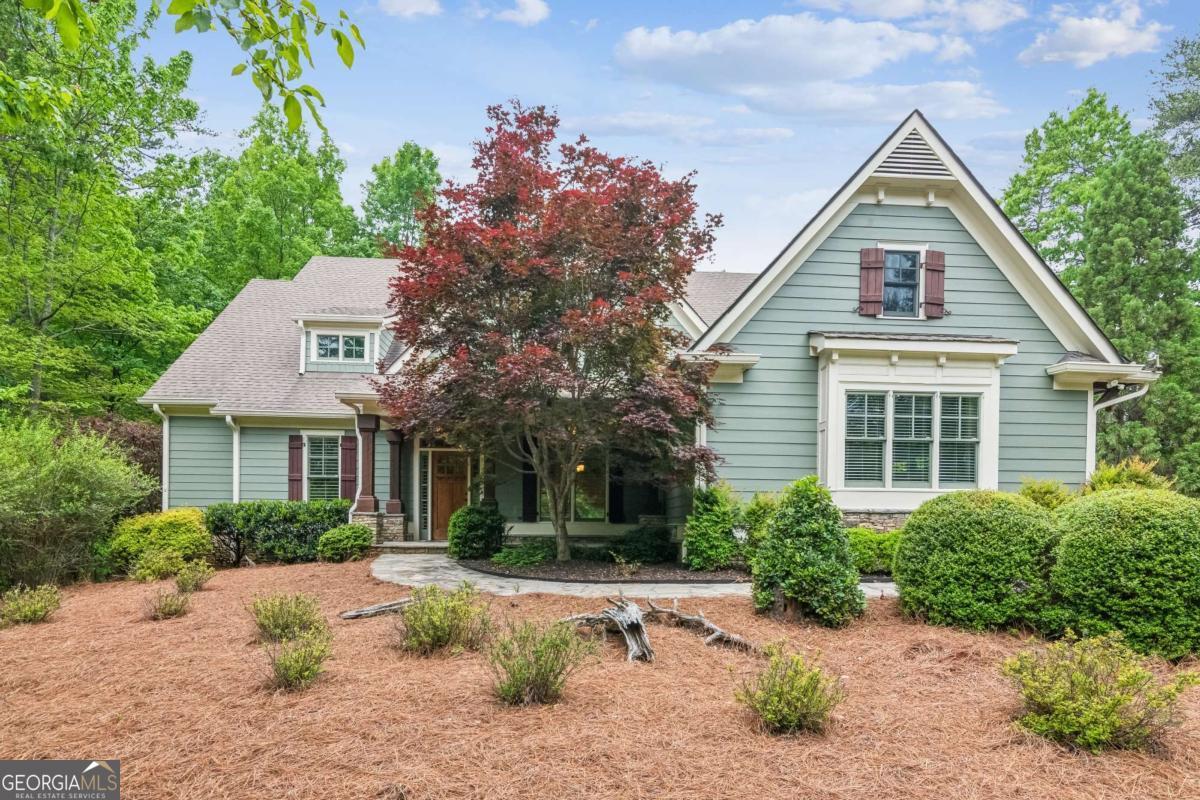 1.35-acre lot in the exclusive Wildcat section of Big Canoe. Discover unmatched privacy, luxury, and craftsmanship in this stunning 4+ bedroom, 4 full bath, 2 half bath home. From the moment you arrive at the quiet cul-de-sac, you'll feel the difference: exquisite architectural details like crown molding, wainscoting, hand-detailed exposed beams, and coffered ceilings create a warm, elegant atmosphere throughout. Designed for everyday comfort and effortless entertaining, the thoughtfully crafted floor plan features hardwood flooring, plantation shutters, and programmable Hunter Douglas shades. The main level offers a luxurious primary suite with a spa-like bath - featuring a walk-in shower, Koehler soaking tub, and double sinks - along with a second bedroom or office space. The incredible lower level extends the living and entertaining space with a second master suite, a stylish terrace bar equipped with a hammered copper sink, leather-textured counters, a wine fridge, ice maker, dishwasher, and a pool table area. Step outside to embrace the best of mountain living: four porches, including a cozy screened side porch with a fireplace and luxury vinyl flooring, plus a brand-new back deck perfect for gatherings or quiet evenings. Additional Features Include: Oversized 3-car garage -attic flooring and pull down metal stairs. Whole-house Kohler generator. Whole-house water filtration system. Aprilaire whole-house dehumidifier. SimpliSafe security system. 3 HVAC units with programmable thermostats. 3 fireplaces - Great Room, Keeping Room & Screen Porch. Bosch dishwasher, gas stovetop. Gutter guards and 2 Phantom door screens. Luxury and functionality meet in every detail - all set within one of the area's most sought-after neighborhoods. Whether you're cozying up by the fireplace, entertaining friends at the terrace bar, or simply enjoying the tranquil wooded views from your screened porch, this home offers a lifestyle like no other. Don't miss this rare opportunity ! **A mandatory $4,500.00 capital contribution fee paid by the purchaser to the Big Canoe Property Owners' Association will be due at closing. **Pursuant to Article II, Section 1, Paragraph bb of the Class "A" Covenants for the Big Canoe community, all property transfers are subject to the Big Canoe developer's right of first refusal.
