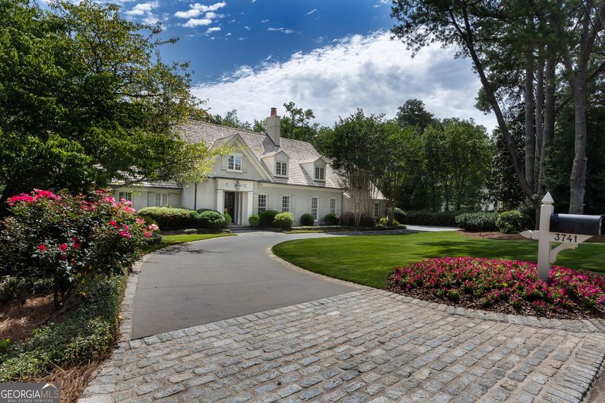 Exquisite Kingswood Estate Nestled in the highly sought-after Kingswood neighborhood, this stunning 5-bedroom, 5-bath residence designed by the acclaimed Spitzmiller & Norris offers timeless elegance and modern comfort. Ideally located close to Atlanta's premier private schools, the home combines classic architecture with thoughtful design and luxurious finishes. Enter the custom designed front entrance with a custom Bevolo lantern and new double iron doors with gold hardware accent. . From the moment you step inside, you are greeted by reclaimed wide plank heart of pine floors, custom millwork, limestone fireplaces and antique light fixtures that add warmth and character to every room. The home is filled with high-end custom finishes throughout, creating a refined yet comfortable living environment. This home was completely renovated in 2005 including taking the original home down to the studs, expanding the footprint and re-imagining modern living while preserving charm with a emphasis on quality and elegant sophistication. The main-level primary suite with a large bay window provides lovely views to the backyard while the upper level features four bedrooms, three baths, and a spacious vaulted family room. Other features included on the main level are custom lockers with brick floors, living room lined with iron doors, Rocky Mountain high end hardware, Marvin windows, dining room with fireplace, library with iron doors opens to stone terrace, home office, large oversized bar and oversized pantry and laundry. Walk out from the family room to a large stone terrace with an inviting pool elevated over an enormous flat backyard. There is also a pool house with a full bath and fireplace make entertaining effortless. This home was designed with an ability to entertain inside and out. The flow from the main house to the beautiful terrace, pool and pool house is seamless. Outdoor moonscape lighting along with lighting around the trees on stone terrace create a magical outdoor atmosphere. This exceptional property is a rare opportunity to own a truly custom home in one of Atlanta's most prestigious neighborhoods.