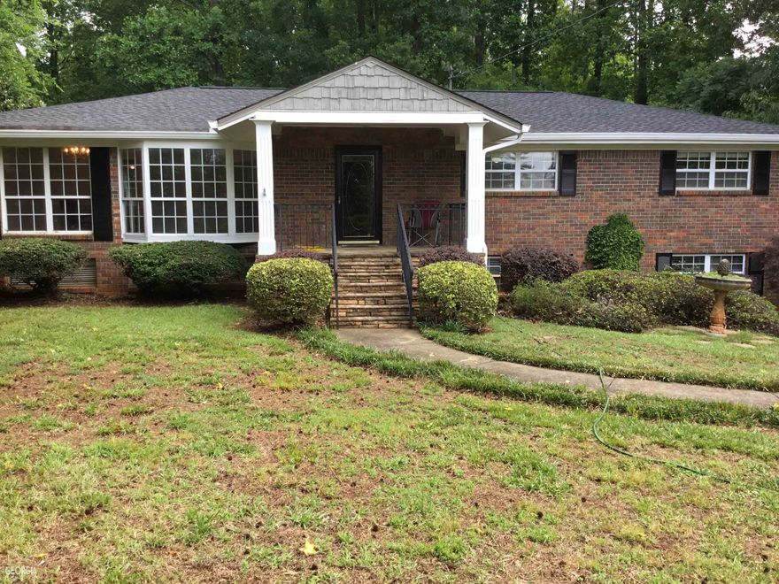 Location is a plus for the Woodstock area. Rare 3 sided Brick, rocking chair front porch, No HOA and lots of mature tree a plenty of landscaping. Property has new roof, HVAC, Paint, Carpet and H2O. Large rooms with designer closets. Basement has some finished rooms and some work in progress and workshop area.