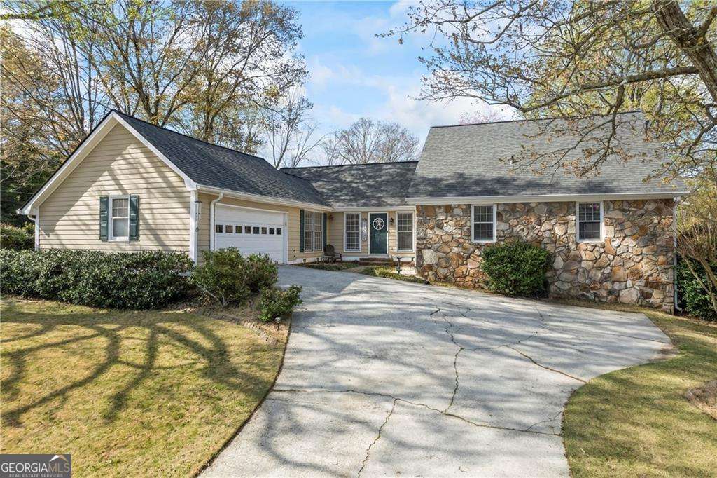 Welcome to this beautifully maintained home located in the highly sought-after Brookwood High School district. This charming two-story residence features four spacious bedrooms and two full bathrooms, offering a perfect blend of comfort, character, and functionality. Situated on a premium one-acre corner lot, the property provides ample outdoor space and exceptional privacy. The home includes a partially finished basement with exterior entry, ideal for storage, a workshop, or future expansion. On the exterior, you'll find a custom-built side porch-a perfect retreat for enjoying summer evenings. The yard also includes a rope tire swing, making it a wonderful outdoor space for children. The fully fenced backyard features a custom pergola, providing shaded seating and a tranquil setting to relax and take in the beauty of the property. Inside, the home boasts brand-new flooring throughout, with three bedrooms conveniently located on the main level, including the primary suite. The kitchen offers ample cabinet and pantry space, catering to all your storage and cooking needs. The family room is a true centerpiece, highlighted by a floor-to-ceiling stone fireplace and cathedral ceilings with exposed beams, adding warmth and architectural charm to the space. The fourth bedroom is located upstairs, offering a private and versatile space ideal for guests, a home office, playroom, or media room-the possibilities are endless. The home also features a half basement with full electrical access, perfect for storing lawn equipment or customizing to your needs. Additional highlights include a brand-new roof installed this year, and a prime location close to major shopping, dining, and amenities-all within a peaceful, established neighborhood. This corner-lot gem is a rare find that combines thoughtful updates, unique character, and unbeatable location. A must-see for any buyer in today's market.