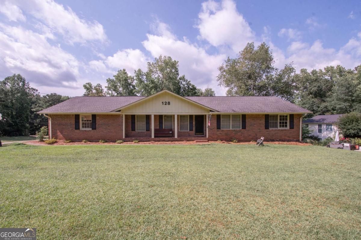 Great 4 sided brick home on quiet street overlooking the large, partially fenced yard. Inside features open living areas with separate dining room, large eat in kitchen and laundry/utility room. 3 good sized bedrooms, master has ensuite bath. An additional bath makes up the main floor. Downstairs, the basement has been finished, with brick fireplace and large living/game area, as well as room for an additional bath. Also, there is a separate, spacious shop area with workbench, and garage door leading to outside, great for storing lawn equipment. This is an amazing home that is move in ready for you! It has new paint, carpet, and new central heating and air!