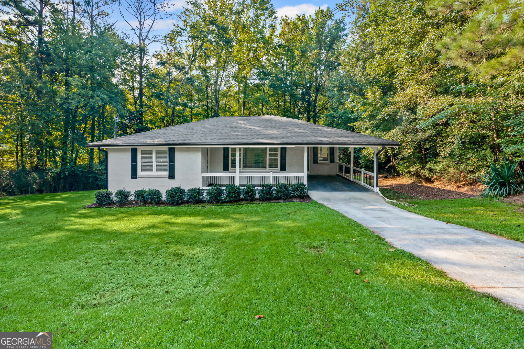 CHARMING BRICK RANCH HOME WITH HARDWOOD FLOORS ON A LARGE CORNER LOT With Attached Carport! Spacious living room / dining room with half bath. Tiled full bath in hall. Kitchen with breakfast area, carport entry, ample cabinet space, stainless appliances, laundry area. Second and third bedrooms can be office and / or guest rooms. Easy access to downtown Newnan. This Home Is A Must See!