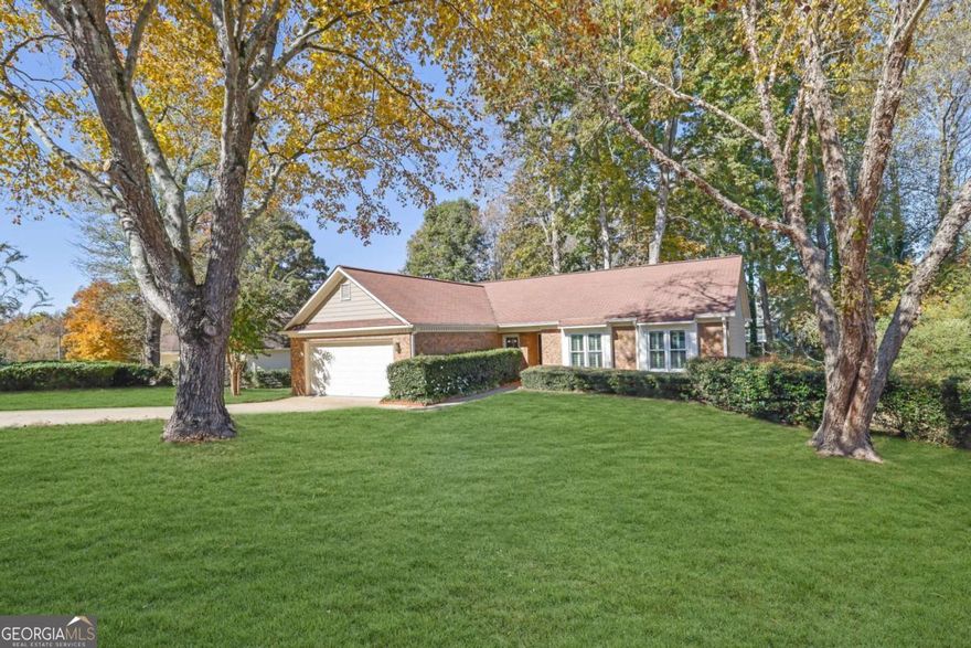 Welcome to this charming one-owner home that has been lovingly cared for and thoughtfully maintained with a FULL KITCHEN REMODEL. Situated on a quiet cul-de-sac road, this step-less brick ranch offers a desirable split-bedroom floor plan designed for comfort and functionality. Step inside to find a versatile flex space ideal for a home office, playroom, or guest room. The open-concept layout allows for a seamless flow between rooms, featuring a vaulted family room with a classic fireplace and French doors leading to a open deck perfect for outdoor gatherings. The inviting eat-in, peninsula-style kitchen offers plenty of counter space and storage thanks to CUSTOM CABINETRY, highlighted by granite countertops, a slate tile backsplash, NEWER stainless steel APPLIANCES, two dining areas, and a convenient serving window. The primary suite provides a peaceful retreat with a double vanity, garden tub, and large walk-in shower. Two additional bedrooms and an additional full bath offer comfort and flexibility for family or guests. Fresh carpet in all the bedrooms. Plantation shutters throughout add timeless charm and character. Light fixtures, ceiling fans, and WINDOWS UPDATED!! Top of the line heating and air with humidifier. Enjoy a private backyard with serene wooded views from the EXTENDED DECK. Swing set and SHED included! With **no HOA restrictions**, you have the freedom to customize your outdoor space to fit your lifestyle. Conveniently located just outside the hustle and bustle, yet close to Town Center at Cobb, KSU, Sam's Club, and endless shopping, dining, and year-round entertainment.