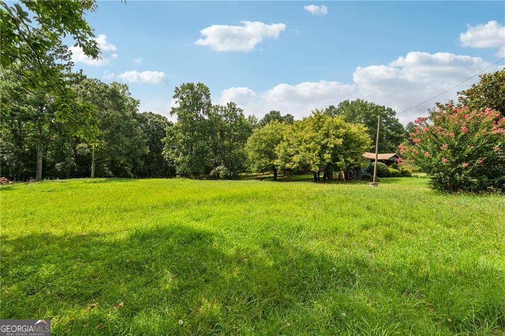 Nestled in the heart of Forsyth County, 8265 Seabolt Drive is a rare gem offering both natural beauty and unlimited potential. This breathtaking property spans a generous expanse of land, providing the perfect canvas for your vision whether it's building a private estate, developing a residential community, or creating an equestrian retreat. Surrounded by lush greenery and picturesque landscapes, the property boasts rolling pastures, mature trees, and serene open spaces, making it an idyllic setting for those seeking peace and privacy without sacrificing convenience. Located just minutes from top-rated schools, shopping, dining, and GA-400, this prime location offers both tranquility and accessibility. With endless possibilities for development, this property presents a rare investment opportunity in one of the fastest-growing areas of metro Atlanta. Whether you're a builder, investor, or dream-home visionary, 8265 Seabolt Drive is a must-see. Don't miss the chance to own this spectacular piece of Cumming's landscape!