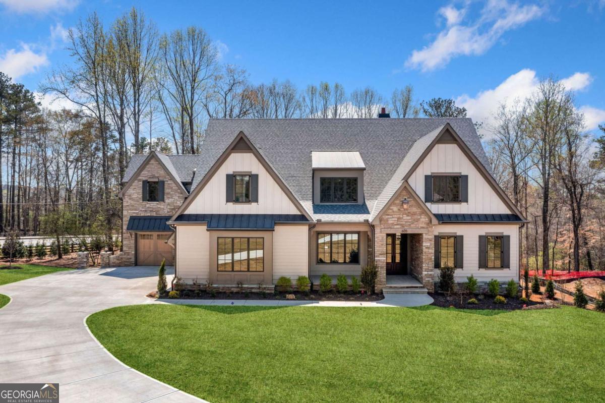 Welcome to Claxton, Chatham Neighborhood's newest luxury community, located in the heart of Milton across from Bell Memorial Park. Claxton features 10 custom-built estate homes on spacious 1+ acre lots, thoughtfully designed and crafted by Vertical Luxury. This exclusive enclave offers unparalleled elegance, superior craftsmanship, and modern convenience in a picturesque setting. With a prime location and meticulously designed homes, Claxton presents a rare opportunity to experience luxury living in one of north Atlanta's most sought-after communities. Timeless open floor plan features great flow and natural light making this home ideal for daily living and entertaining guests. The home features a well appointed trim package that includes built-ins, paneled walls, shiplap ceilings and beamed cathedral ceilings which are spectacular and PELLA windows and doors. The great room with fireplace and opens to outside living spaces. Owner's suite on main with spa like bathroom, with soaking tub, and a massive walk in closet. Spacious and stunning chef's kitchen with top of the line Thermador appliances, oversized island, quartz countertops and custom cabinetry and a scullery providing ample space for pantry storage, a mud room and a laundry room on route to the 3 car garage. Additional Ensuite Bedroom/Office on main level. Secondary level features 4 bedrooms with 4 full baths, a bonus room loft and second laundry room. Floored attic storage area. Terrace level has ideal layout for completion. Stubbed for bath. Expansive outdoor living area with fireplace, outdoor kitchen and dining area overlooking backyard which is ideal for a pool.