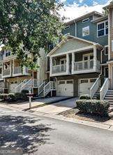 Located in the gated Liberty Park community on Atlanta's vibrant Upper Westside, 1208 Liberty Parkway NW offers the perfect blend of modern convenience, thoughtful design, and secure, community-focused living. This three-story townhome features an open, light-filled layout with hardwood floors throughout the main level, seamlessly connecting the living room, dining area, and kitchen. The kitchen is well-appointed with granite countertops, white cabinetry, stainless steel appliances, and a breakfast bar ideal for casual dining or entertaining. A conveniently located half bath on the main level enhances everyday functionality. Enjoy two private outdoor spaces - a front balcony off the living room and a rear deck off the dining area - perfect for morning coffee, evening relaxation, or hosting guests. Upstairs, two generously sized bedrooms - each with vaulted ceilings - serve as dual primary suites, both featuring en-suite bathrooms and walk-in closets. A hallway laundry room, situated between the two bedrooms, adds additional convenience. The lower level offers a versatile third bedroom or bonus space with a half bath, ideal for a home office, guest suite, or fitness area. Additional highlights include a one-car garage, driveway parking, and ample storage throughout the home. Liberty Park residents enjoy 24-hour gated security, a community pool, and a dog park. The location offers quick access to Westside hotspots such as The Works, Westside Village, and numerous restaurants, parks, and retail. Midtown, Downtown, and major highways are all just minutes away, making commuting a breeze. Move-in ready, this home delivers comfort, style, and convenience in the best of Atlanta's Upper Westside lifestyle.