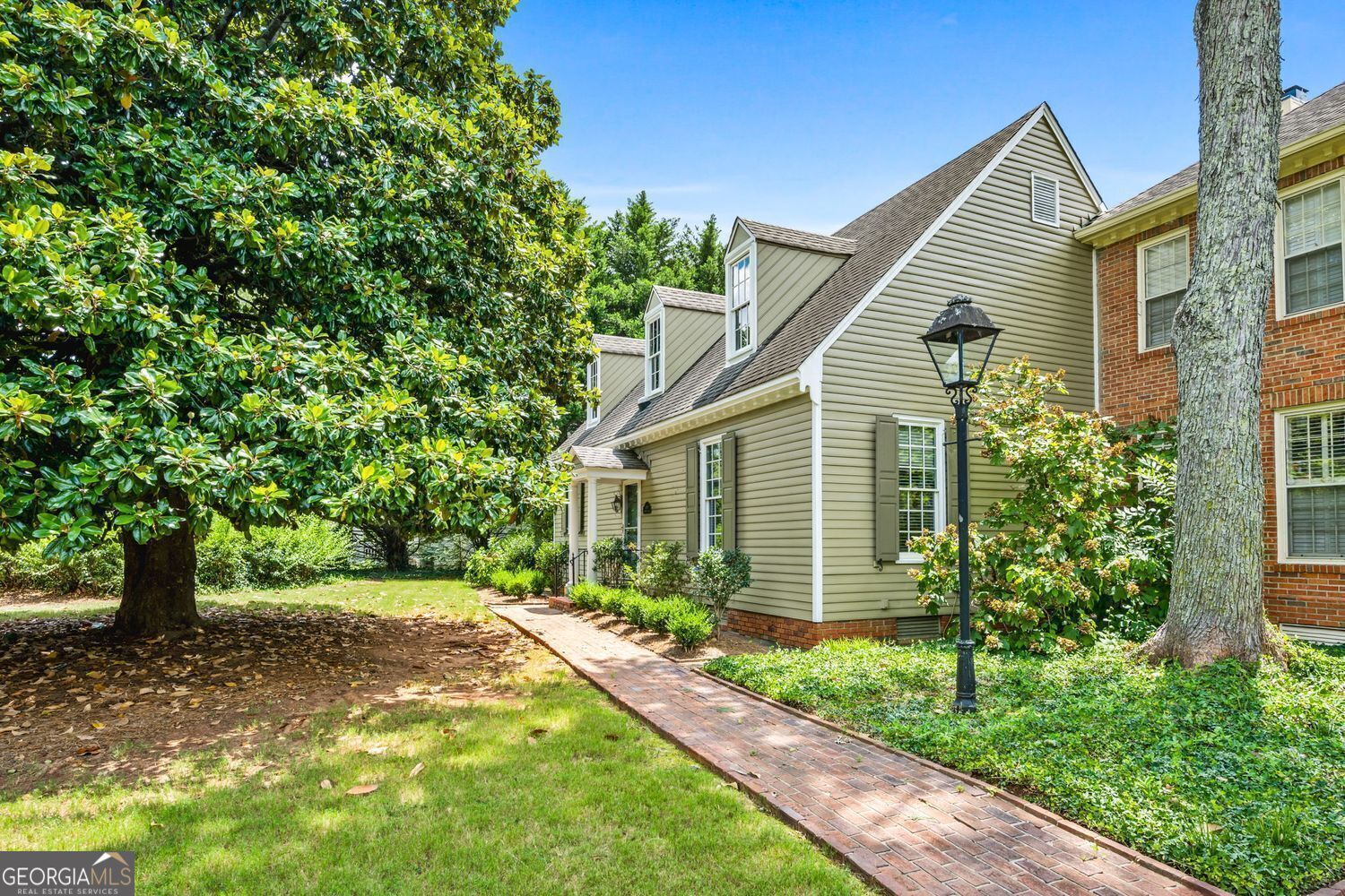 Located on one of Marietta's most storied streets, 490 Chowning Place is a rare gem, a meticulously designed replica of Colonial Williamsburg architecture set in the heart of the Kennesaw Avenue Historic District. This beautifully updated 2-bedroom, 2-bath home offers one-level living with unmatched charm, character, and location. Inside, you'll find wide plank real pine floors, 9-foot ceilings, and an open living and dining concept anchored by a classic wood-burning fireplace. The kitchen has been tastefully updated with quartz countertops, modern appliances, and a bright eat-in breakfast area-perfect for both everyday living and entertaining. The oversized primary suite features a fully renovated bathroom with granite counters and a subway-tiled walk-in shower. Outside is a large private brick courtyard-fully fenced, lushly landscaped, and ideal for relaxing or gathering with guests. Additional features include a detached two-car garage, authentic wood siding, and a prime location near Wellstar Hospital, Marietta's most prominent antebellum and historic homes, and all the dining, shopping, and culture of the Marietta Square. Located in a highly sought-after community, this home offers a rare blend of historic character and modern comfort-an opportunity not to be missed.
