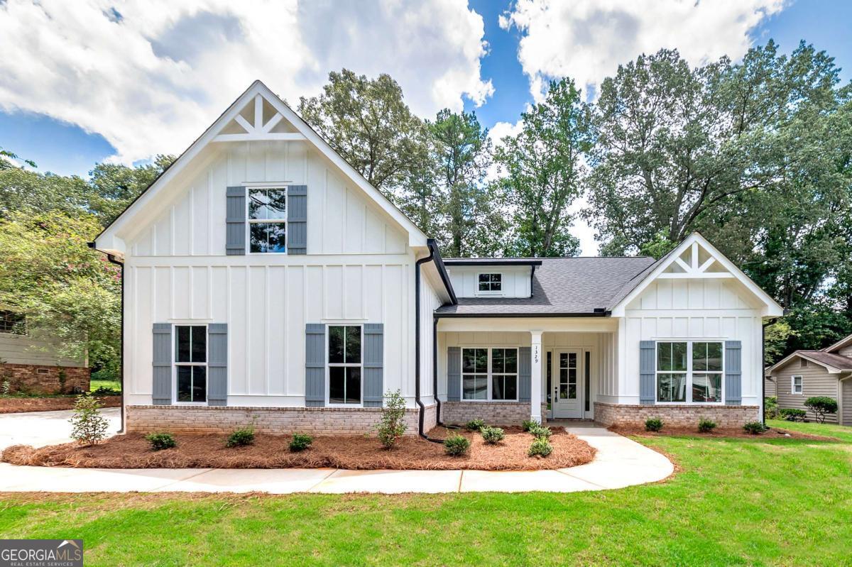 $5,000 incentive with preferred lender! Stunning brand new ranch-style home perfectly positioned in the heart of Sugar Hill, nestled within a beautiful and established neighborhood. Thoughtfully designed for modern living, this spacious 4-bedroom, 3-bath home effortlessly blends luxury, comfort, and convenience. From the moment you enter, you'll notice the high-end finishes, including durable and stylish LVP flooring that runs throughout the home. The open floor plan flows seamlessly from the elegant foyer into a light-filled family room featuring a cozy gas fireplace - the perfect place to unwind or entertain guests. The chef's kitchen is a true centerpiece, boasting custom high-end cabinetry, gleaming quartz countertops, and ample workspace for any culinary endeavor. A separate formal dining room offers an ideal setting for hosting dinners and holiday gatherings. Just off the garage, a custom-built mud bench adds both charm and functionality for everyday convenience. The home's layout includes three bedrooms on the main level, including a luxurious master suite with generous proportions and a spa-like en suite bath. Upstairs, a private fourth bedroom and full bath create the perfect retreat for guests, teens, or a quiet home office. Step outside to enjoy a covered rear patio overlooking a peaceful and private backyard - a serene space to relax or entertain year-round. Located just moments from Sugar Hill's vibrant downtown, parks, shops, and dining, this home offers the best of both privacy and proximity. Don't miss your chance to own this rare new-construction gem in one of the area's most charming communities.