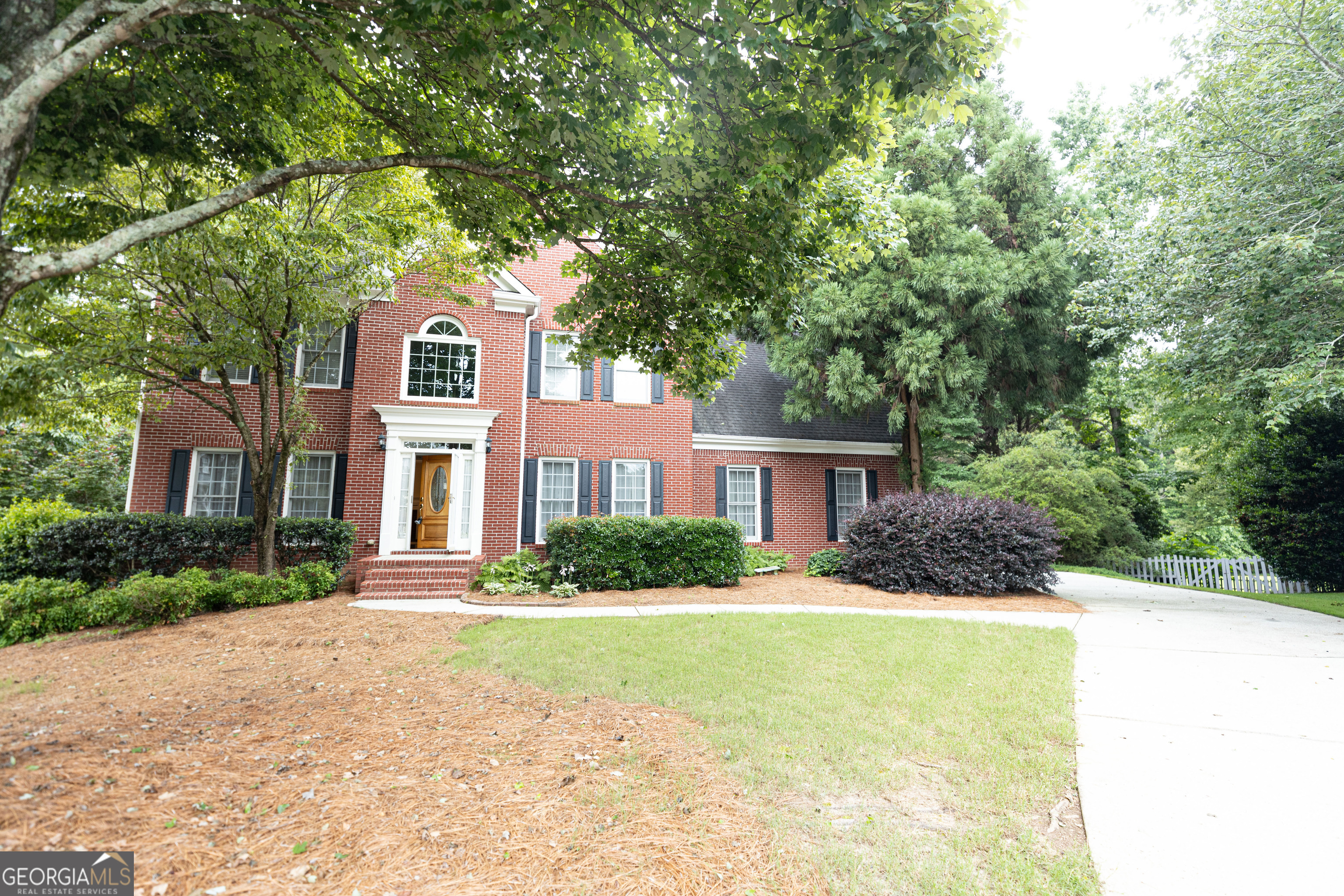 Welcome to Your Dream Home in one of Lilburn's sought-after communities. Located in the CUL-DE-SAC LOT, this lovely home is one of the best lots in the community with a beautiful nature's paradise. This timeless brick front hillside home offers a stunning landscape. As you enter the gracious foyer, you will immediately notice with open-floor concept with luxury hardwood floor on the main level, lots of natural light, and traditional two-access stairs. Windows surrounding the living room and kitchen offer the best natural light throughout. A spacious family room opens to a fully equipped kitchen with white cabinetry and granite countertops with views to the generously sized sunroom, which is a fantastic deck with a pergola that lets in the perfect ratio of sunlight and shade. Upstairs are 4 bedrooms and 2 full baths. The great-sized primary suite features a huge walk-in closet, cedar closet, and a separate sitting room_perfect for a home office, nursery, or relaxing area. Three other spacious bedrooms upstairs share a full bathroom. Basement with 1 bedroom and 1 full bathroom, and an entertainment room for a small separate family. Additionally, this elegant home also offers a level backyard, perfect for entertaining and enjoying endless outdoor fun. Conveniently located close to schools, shopping, dining, entertainment, and minutes away from Main Street Lilburn and Lilburn City Park, Emory University, Decatur, and the CDC. SECTION 8 HOUSING VOUNCHER IS WELCOME