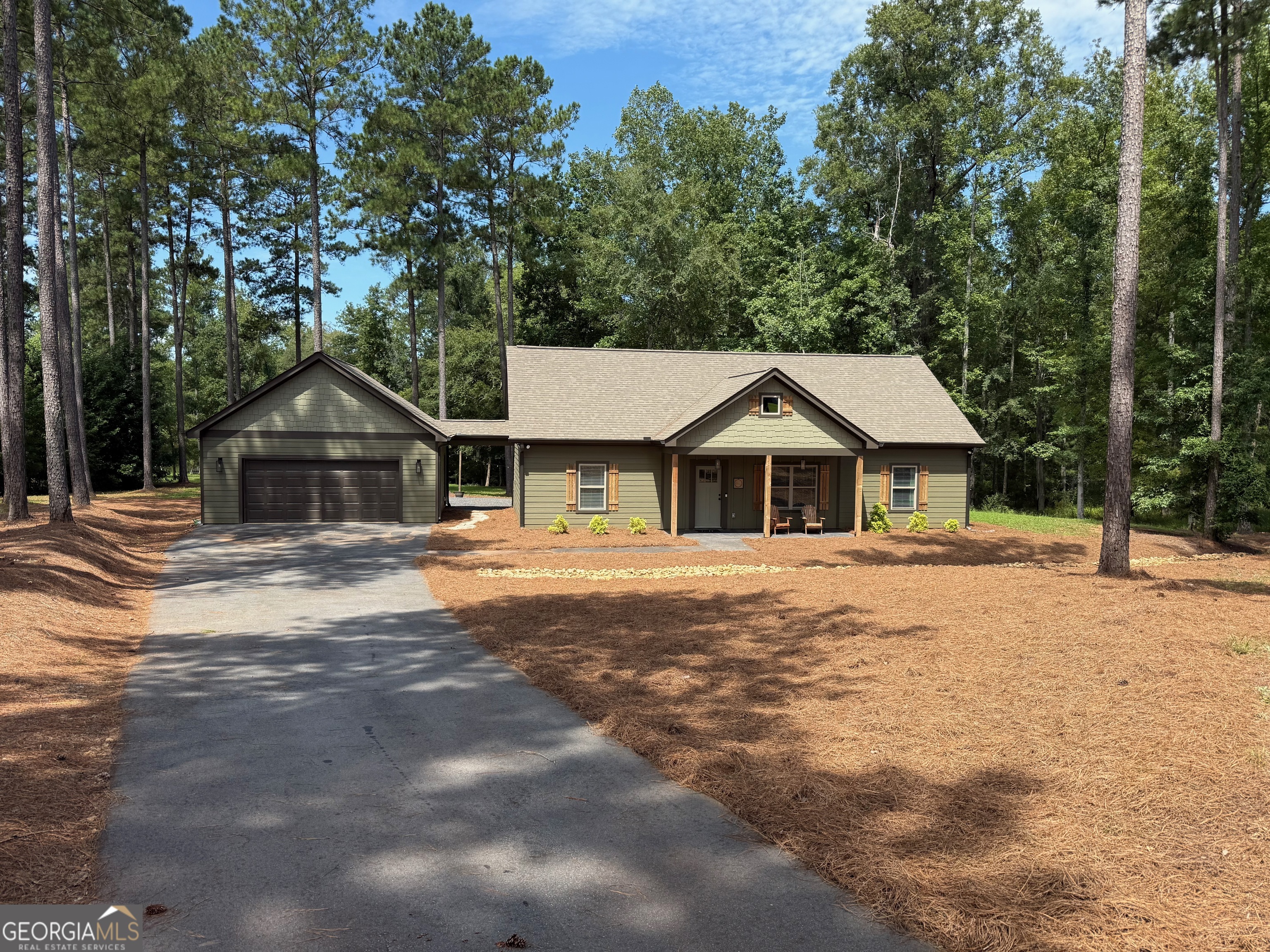 Welcome to your dream lakehouse, perfectly situated on 3.41 private acres in a gated community. Completed in 2022 and used only as a vacation home, this property feels like new and offers the perfect blend of modern comfort and low-maintenance living. A long, private driveway leads to this thoughtfully designed home with durable Hardie siding and a detached two-car garage. Inside, you'll find an open floor plan highlighted by luxury vinyl plank flooring throughout, quartz countertops, soft-close cabinetry, and a stylish tiled backsplash in the kitchen. Bathrooms feature tiled tubs, with a double vanity in the master suite. Enjoy year-round outdoor living with a covered porch and patio, plus a low-maintenance slate chip backyard. Best of all, the property includes a covered dock with a powered lift and swim platform, making lake days effortless and enjoyable. Rarely used and meticulously maintained, this lakehouse offers a like-new experience in a beautiful, private setting. Don't miss your chance to own this exceptional retreat!