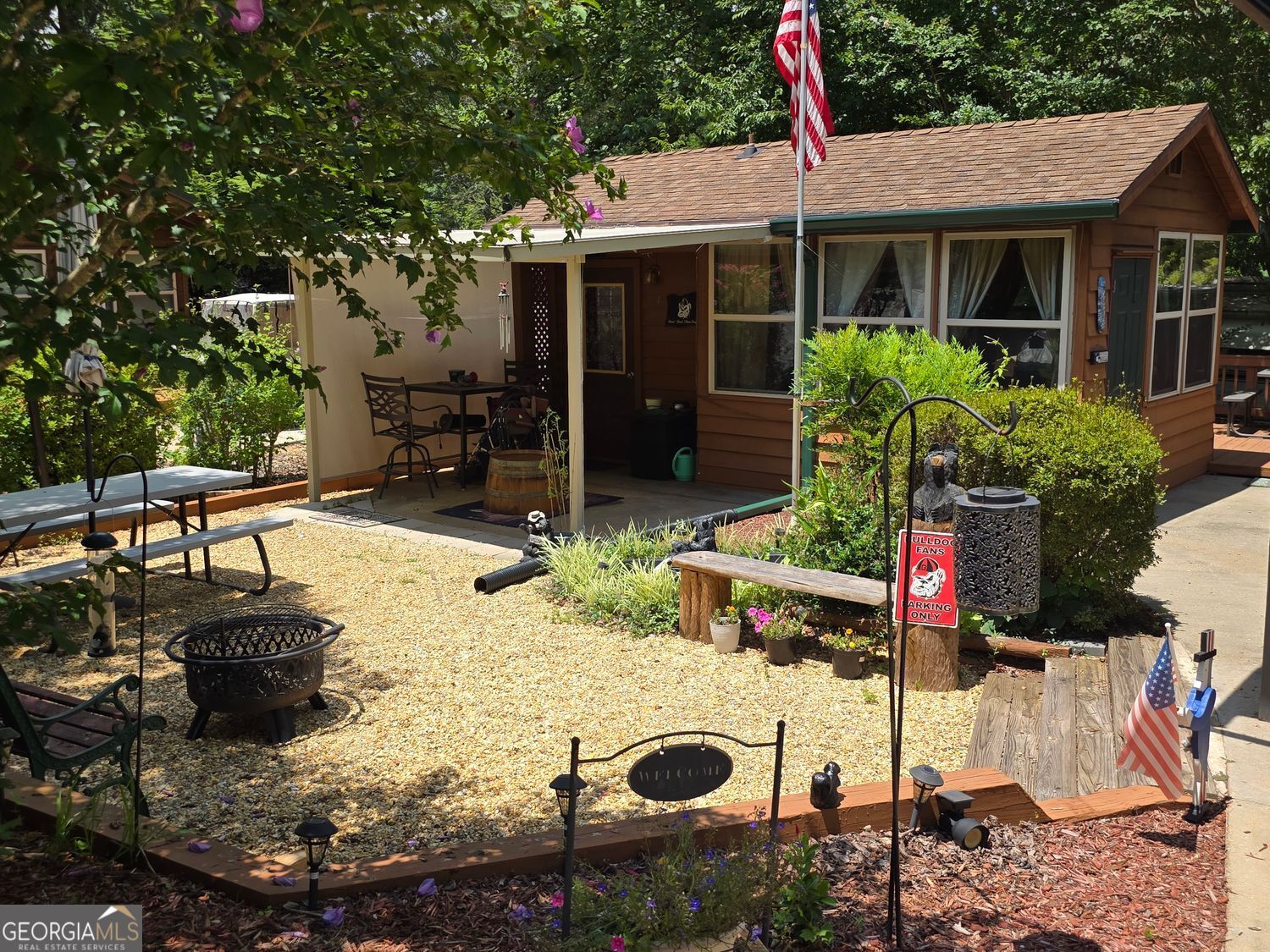Welcome to your mountain retreat at 14 Hidden Valley Rd in the gated Paradise Valley Campground! This inviting property features a well-appointed cottage alongside a 2014 Cottage by Cedar Creek RV and offers a full bath, kitchen, and laundry facilities for all the comforts of home. A trout-stocked creek meanders through the campground, perfect for relaxing by the water or casting a line. The friendly community hosts regular get-togethers, and amenities include a beautiful pool and pavilion for cookouts and social events. Short-term rentals are allowed, offering great potential for return on your investment when you're not enjoying it yourself. Located just minutes from downtown Helen and a short drive to Gainesville, this property combines convenience, comfort, and mountain charm-ideal for full-time living, a vacation getaway, or rental income.