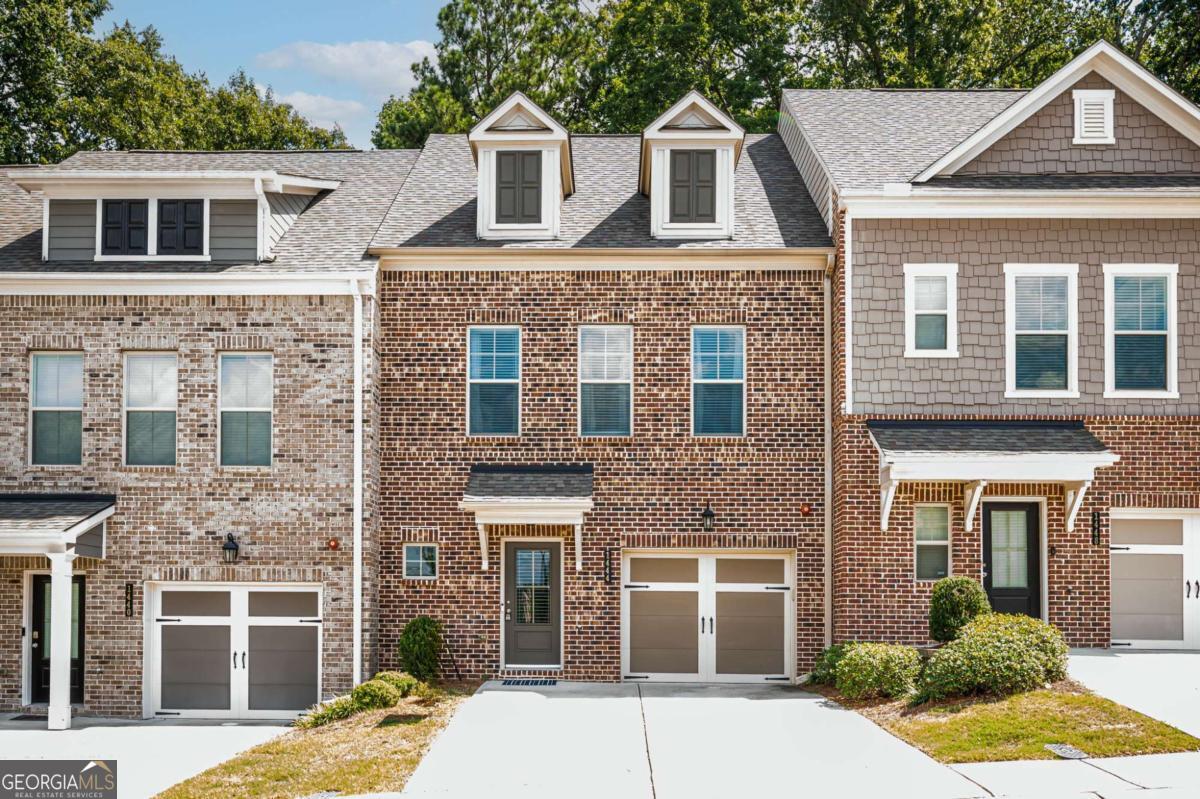 Welcome to 1444 Ridge Bend Way SE, a beautifully maintained 3-bedroom home at Brookside Lake Manor. Built in 2020, this Taylor Morrison residence offers a modern open floor plan designed for today's lifestyle. The main level features two versatile flex rooms that can serve as a home office, playroom, or guest space, along with a cozy fireplace that anchors the living area. The kitchen flows seamlessly into the dining and living spaces, making it perfect for both everyday living and entertaining. Upstairs, you'll find three spacious bedrooms, including a serene primary suite. A one-car garage provides convenient parking and storage. The community itself offers fantastic amenities including a pool, scenic walking trails, and a dedicated dog walk area-ideal for both relaxation and recreation. Move-in ready and in pristine condition, this home combines modern design with comfort and convenience, all in a vibrant neighborhood setting.