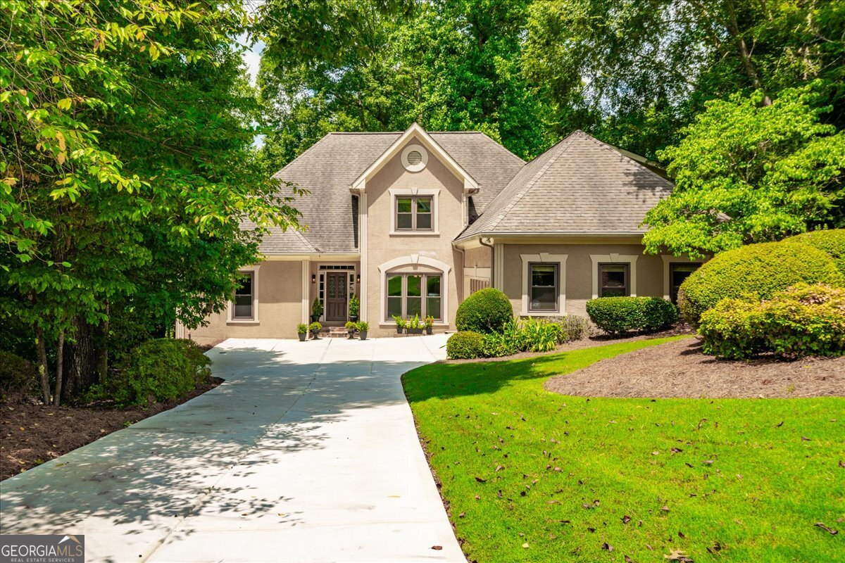 Elegant 6-Bedroom European-Style Home in Sought-After Johns Creek / Northview HS District Welcome to The Hideaway at Stonehaven-a beautifully crafted 4,930 sq ft European-style residence that seamlessly blends timeless elegance with modern comfort. Nestled in one of Johns Creek's most desirable swim and tennis communities and zoned for the top-ranked Northview High School, this exceptional home offers refined living in an unbeatable location. The home is minutes away from the Johns Creek Town Center/Medley development, set to open in 2026. With 6 spacious bedrooms and 4.5 luxurious bathrooms, the open-concept design is ideal for both everyday life and stylish entertaining. The chef's kitchen flows effortlessly into the inviting family room, while the dramatic great room showcases vaulted beamed ceilings and a striking see-through stone fireplace. The expansive main-level primary suite features elegant tilework and a generous walk-in closet. Step directly from your bedroom or family room onto a newly renovated full-sized deck-perfect for sipping morning coffee or evening wine while enjoying serene views of the pristine backyard and the gentle sounds of Johns Creek flowing just beyond the trees. Upstairs, you'll find three additional bedrooms, while the fully finished terrace level includes a large recreation room, private office, exercise room, workshop, and abundant unfinished storage space. Outdoors, your private retreat awaits: a full-length screened porch with separate lounging, dining, and bar areas overlooking a lush, landscaped backyard oasis, complete with a stone patio and cozy firepit-ideal for year-round relaxation and gatherings. This remarkable home offers the perfect blend of luxury, privacy, and location-an exceptional opportunity in one of Metro Atlanta's most prestigious communities.