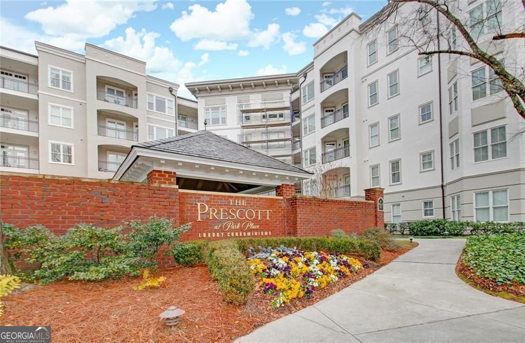 Outstanding Location in the Heart of Dunwoody! Welcome to this beautifully updated top-floor unit in a quiet, highly sought-after community, ideally located next to the newly renovated Park Place-featuring vibrant shops and some of Dunwoody's best dining. This bright and airy home offers an open-concept layout that connects the kitchen, dining/office area, and family room. Enjoy high ceilings, elegant crown molding, brand-new wood flooring, and freshly painted interiors throughout. The kitchen showcases updated white cabinetry and opens into a warm, inviting living space with a fireplace and direct access to a private balcony-perfect for relaxing or entertaining. The spacious floor plan includes two large bedrooms, both with generous walk-in closets. The primary suite features a spa-like en-suite bathroom with a new double vanity cabinet, soaking tub, and separate shower. The secondary bathroom offers updated white cabinetry, shower/tub combo, and a storage closet. Additional highlights include a private storage unit conveniently located and TWO COVERED side-by-side parking spaces. Plus, there's ample guest parking available right in front of the building, thanks to the adjacent Park Place center. Community amenities elevate the experience with a concierge, dog park, fitness center, salt water pool, and a pavilion with grilling area. Easy walkability to many shops, restaurants and Perimeter Mall. Located near top hospitals, and major highways including GA-400, I-285, and I-85-this home offers the ultimate in comfort, convenience, and lifestyle. LEASING PERMIT AVAILABLE - Unit can also be leased from Seller -